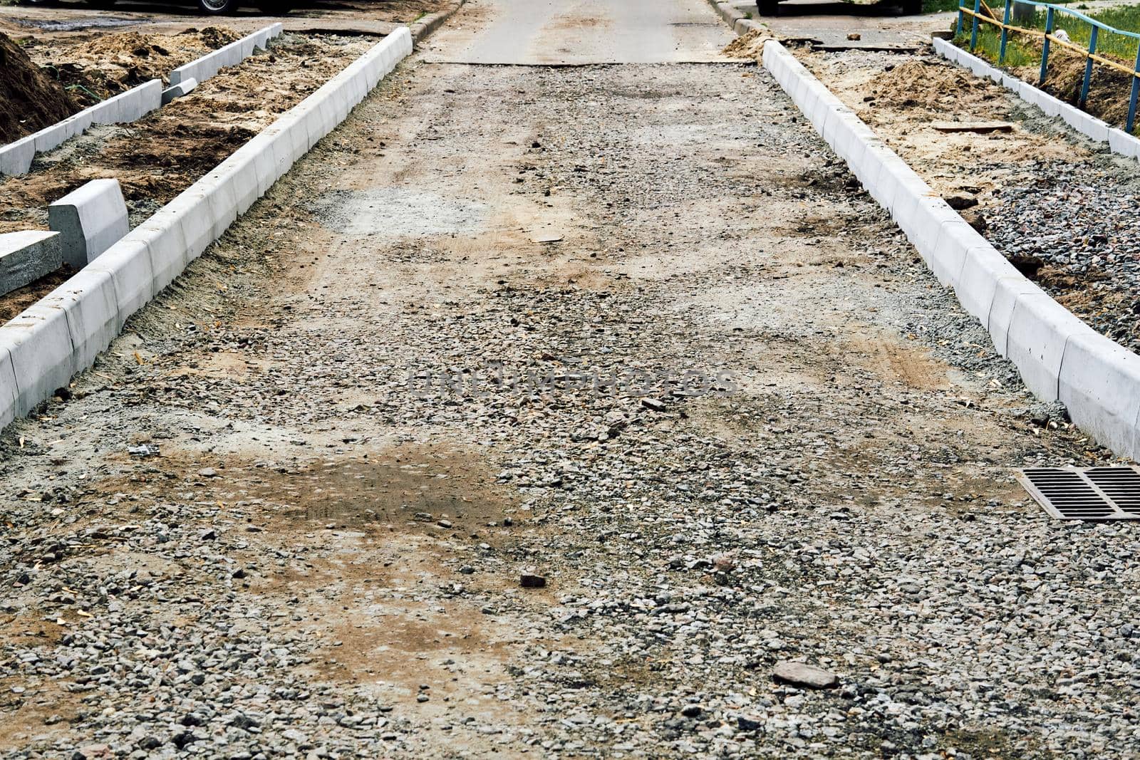 the material laid down to form a road. Roadbed with crushed stone prepared for asphalt laying.