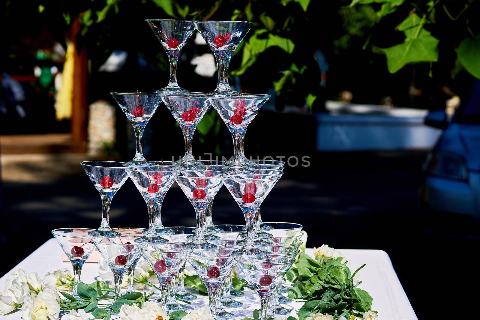 A summer spring wedding cocktail glasses with berries on a warm festive day by jovani68