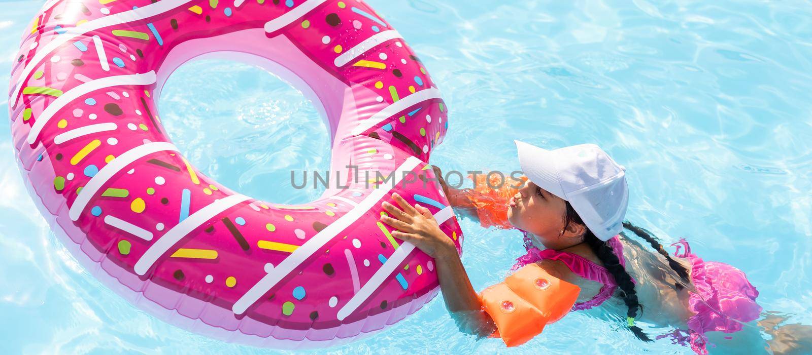 Swimming - little girl playing in blue water - space for text