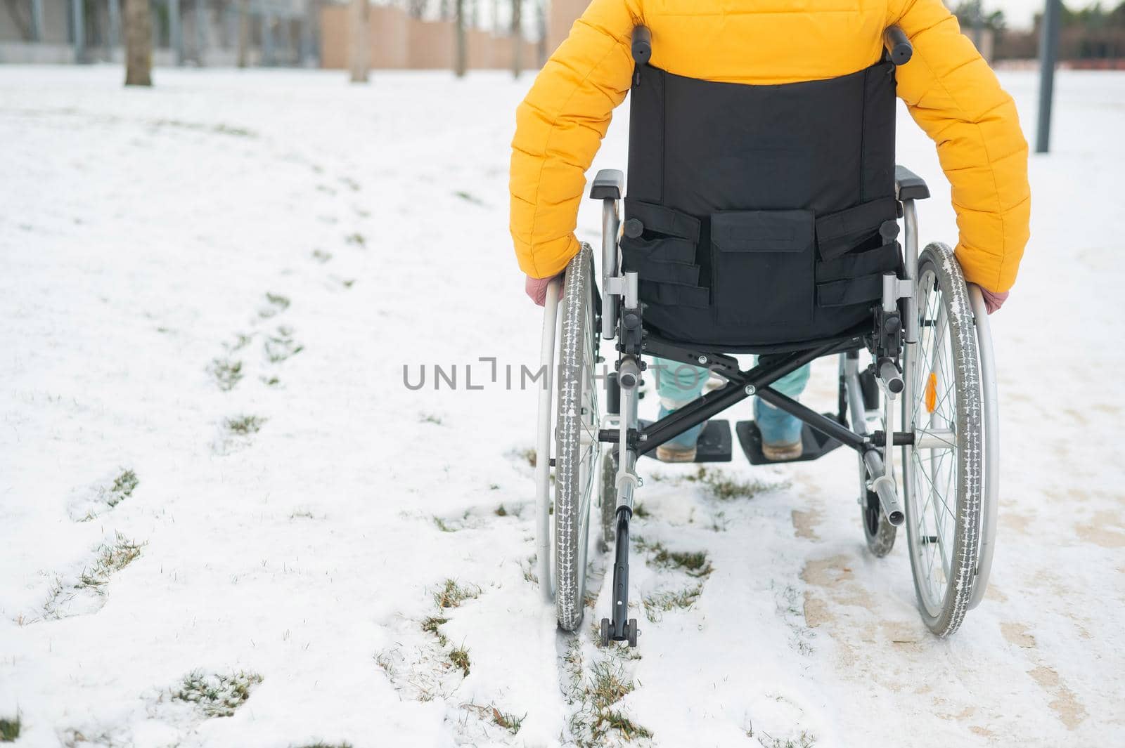 Cropped frame of a woman in a wheelchair in winter