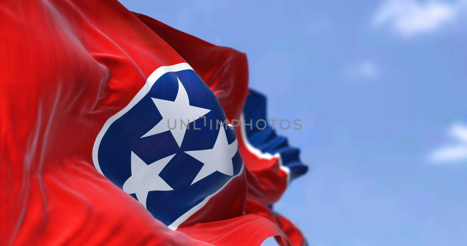The US state flag of Tennessee waving in the wind. Tennessee is a state in the Southeastern region of the United States. Democracy and independence.