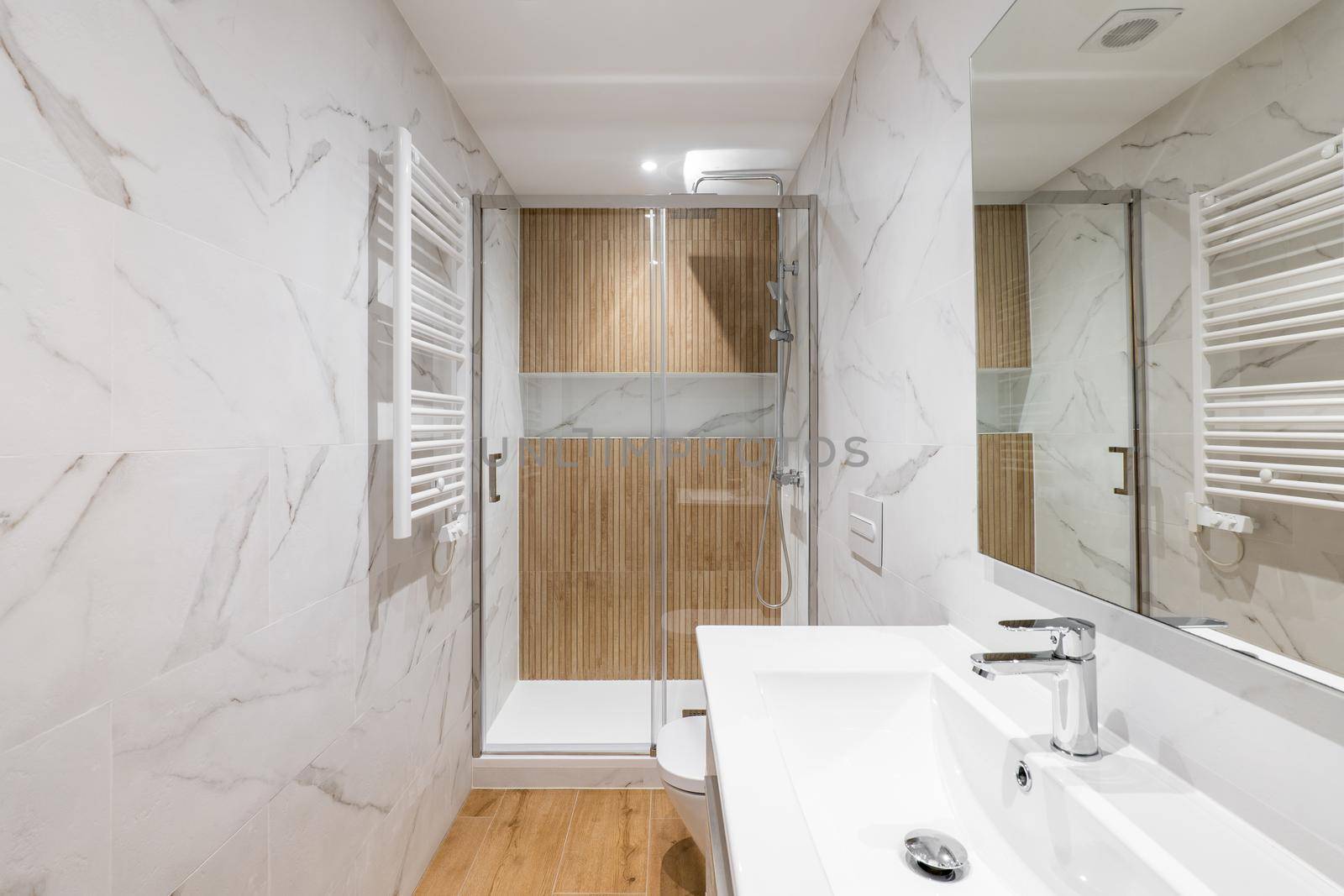Interior of modern refurbished bathroom with shower and wooden finishing by apavlin