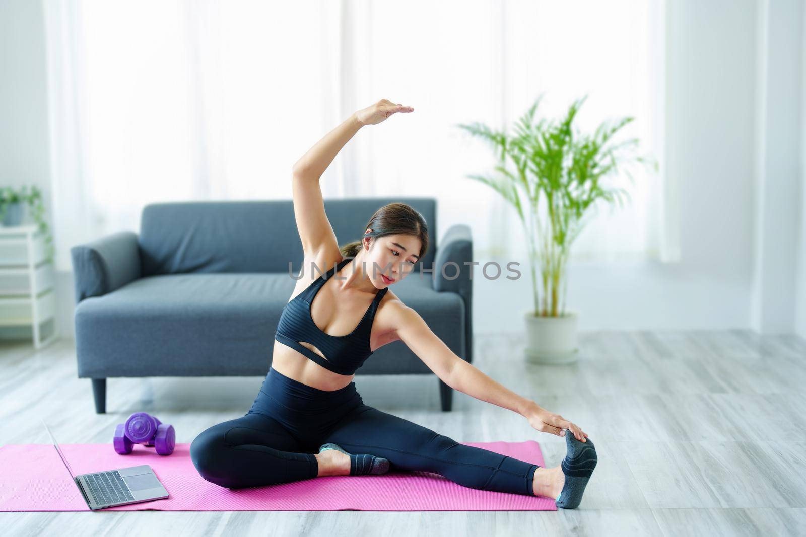 stress relief, muscle relaxation, breathing exercises, exercise, meditation, portrait of Young Asian woman relaxing her body from office work by practicing yoga by watching online tutorials