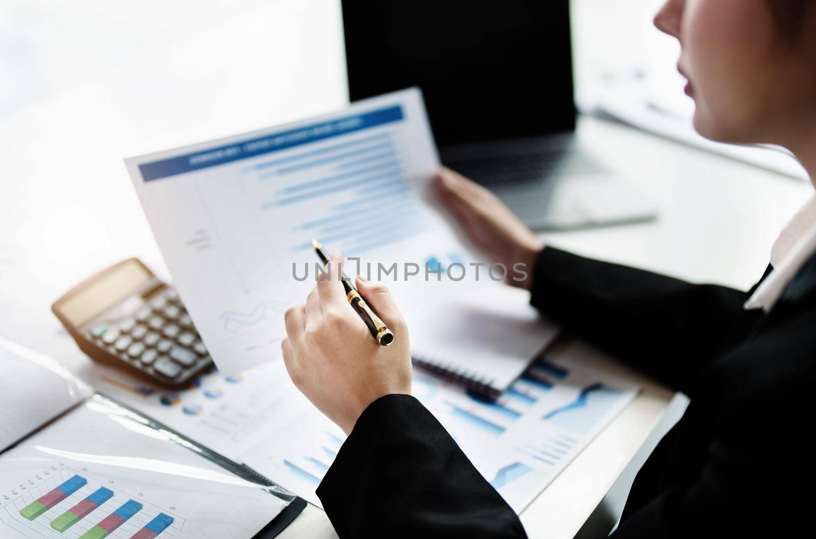 data analysis, plan, marketing, accounting, audit, asian business woman holding pen of planning marketing using statistical data sheet and calculator to present marketing plan project at meeting. by Manastrong