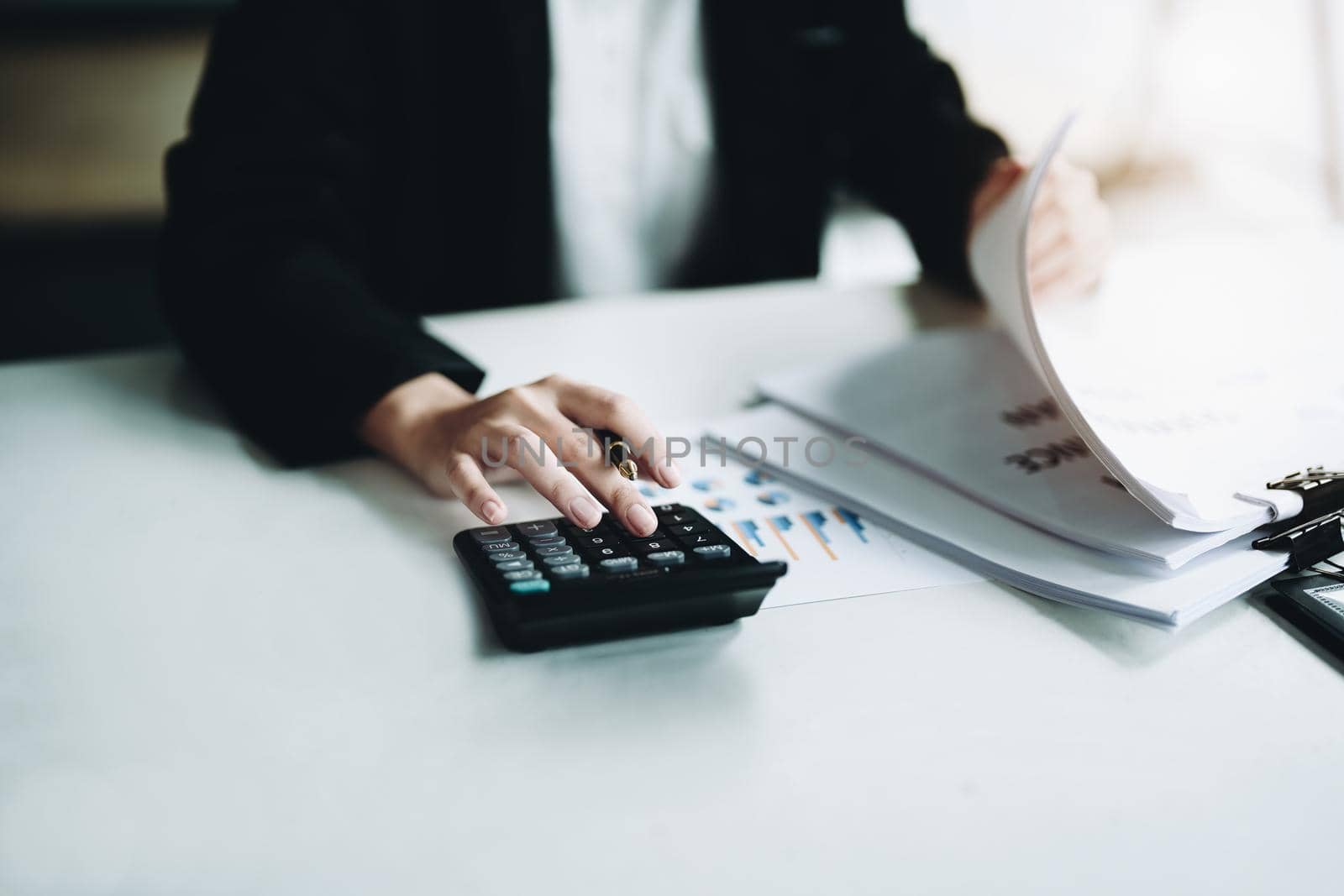 accountant, Auditor, Self-Employed, Finance and Investment, tax calculation and budget, Asian female entrepreneur using a calculator to calculate. Company business results document. by Manastrong