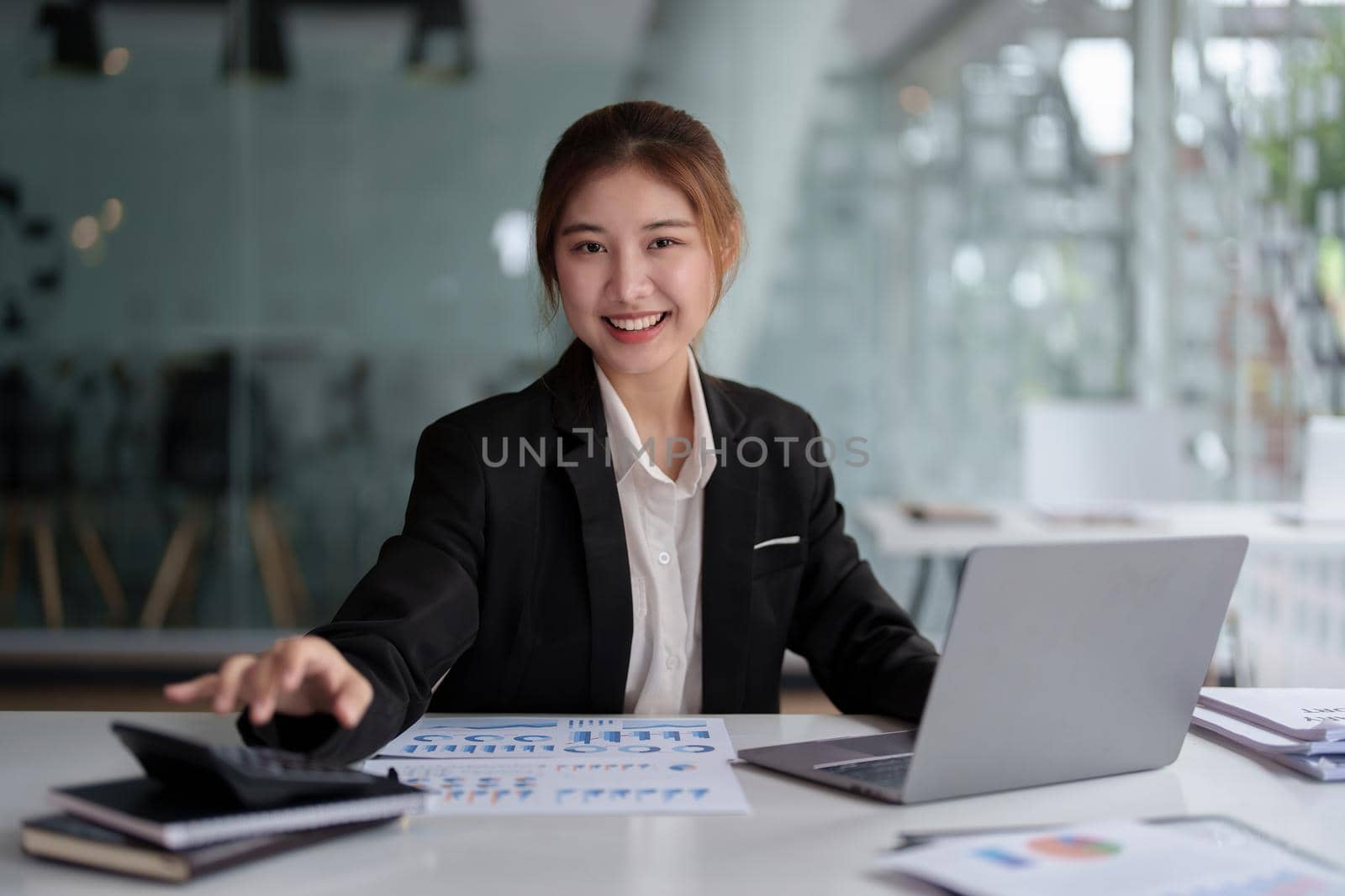 accountant, Auditor, Self-Employed, Finance and Investment, tax calculation and budget, Portrait of Asian female entrepreneur using a calculator to calculate. Company business results document. by Manastrong