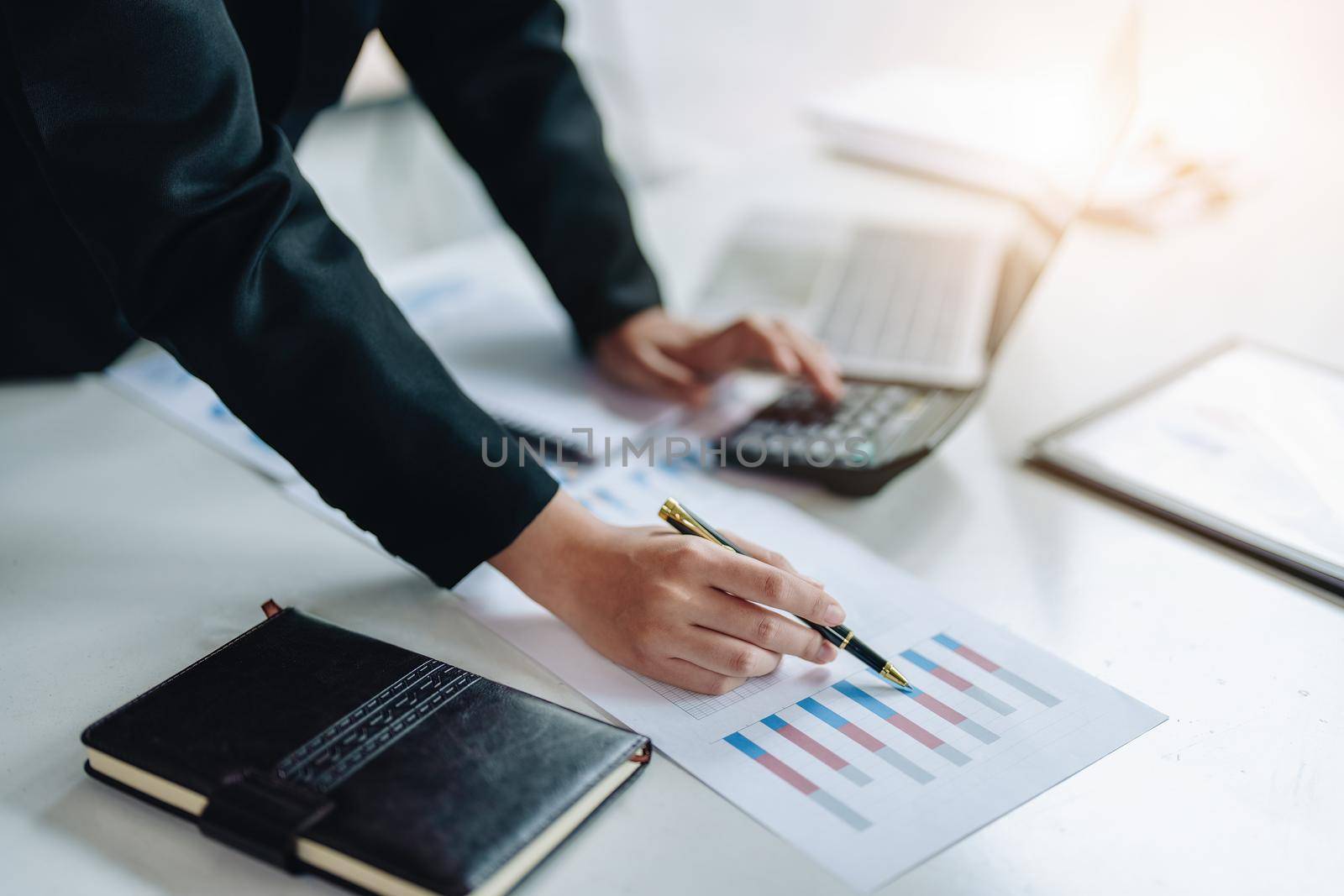 data analysis, plan, marketing, accounting, audit, asian business woman holding pen of planning marketing using statistical data sheet and calculator to present marketing plan project at meeting. by Manastrong