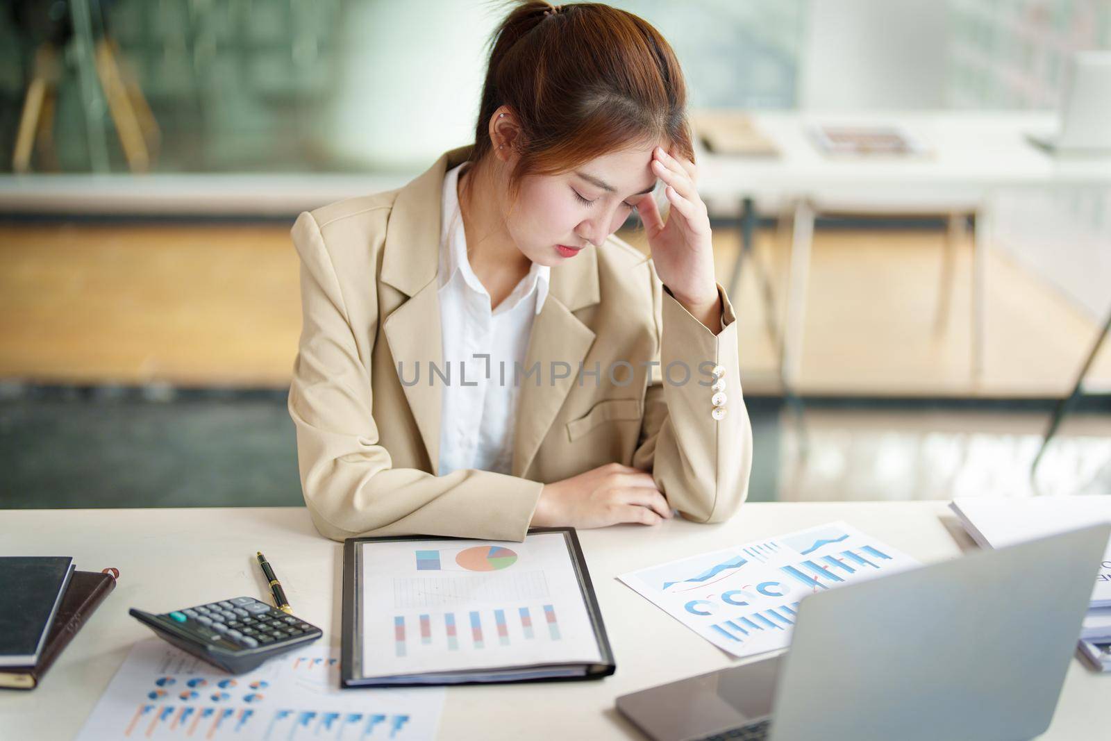 Burnout Syndrome. Portrait of Asian Business Woman feels uncomfortable working. Which is caused by stress, accumulated from unsuccessful work And less resting body. Consult a specialist psychiatrist