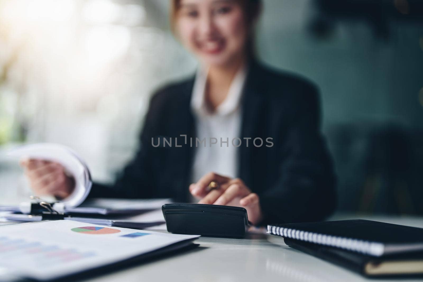 accountant, Auditor, Self-Employed, Finance and Investment, tax calculation and budget, Asian female entrepreneur using a calculator to calculate. Company business results document