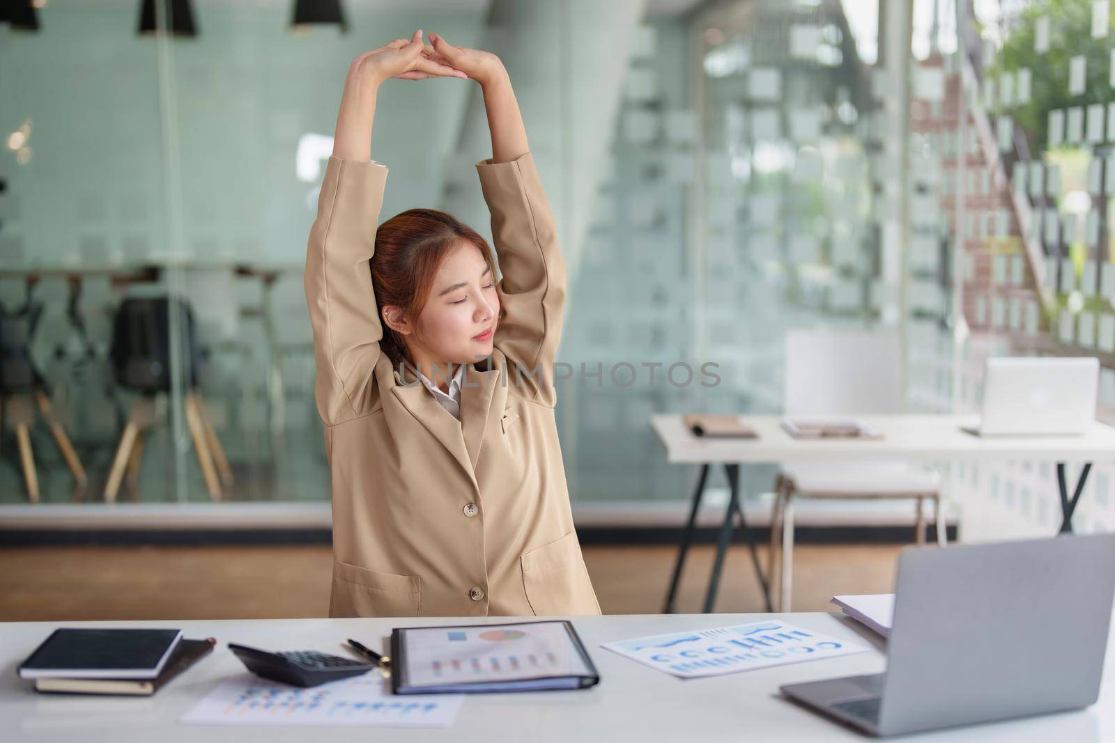 Burnout Syndrome. Portrait of Asian Business Woman feels uncomfortable working. Which is caused by stress, accumulated from unsuccessful work And less resting body. Consult a specialist psychiatrist