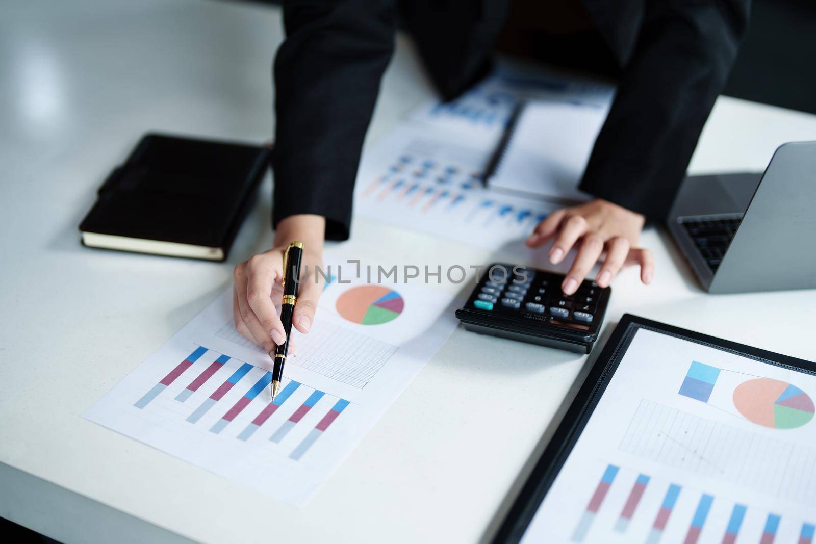 data analysis, plan, marketing, accounting, audit, asian business woman holding pen of planning marketing using statistical data sheet and calculator to present marketing plan project at meeting. by Manastrong