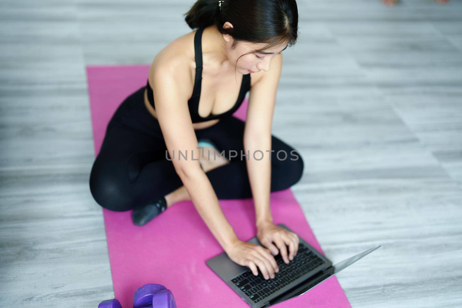 stress relief, muscle relaxation, breathing exercises, exercise, meditation, portrait of Young Asian woman relaxing her body from office work by practicing yoga by watching online tutorials