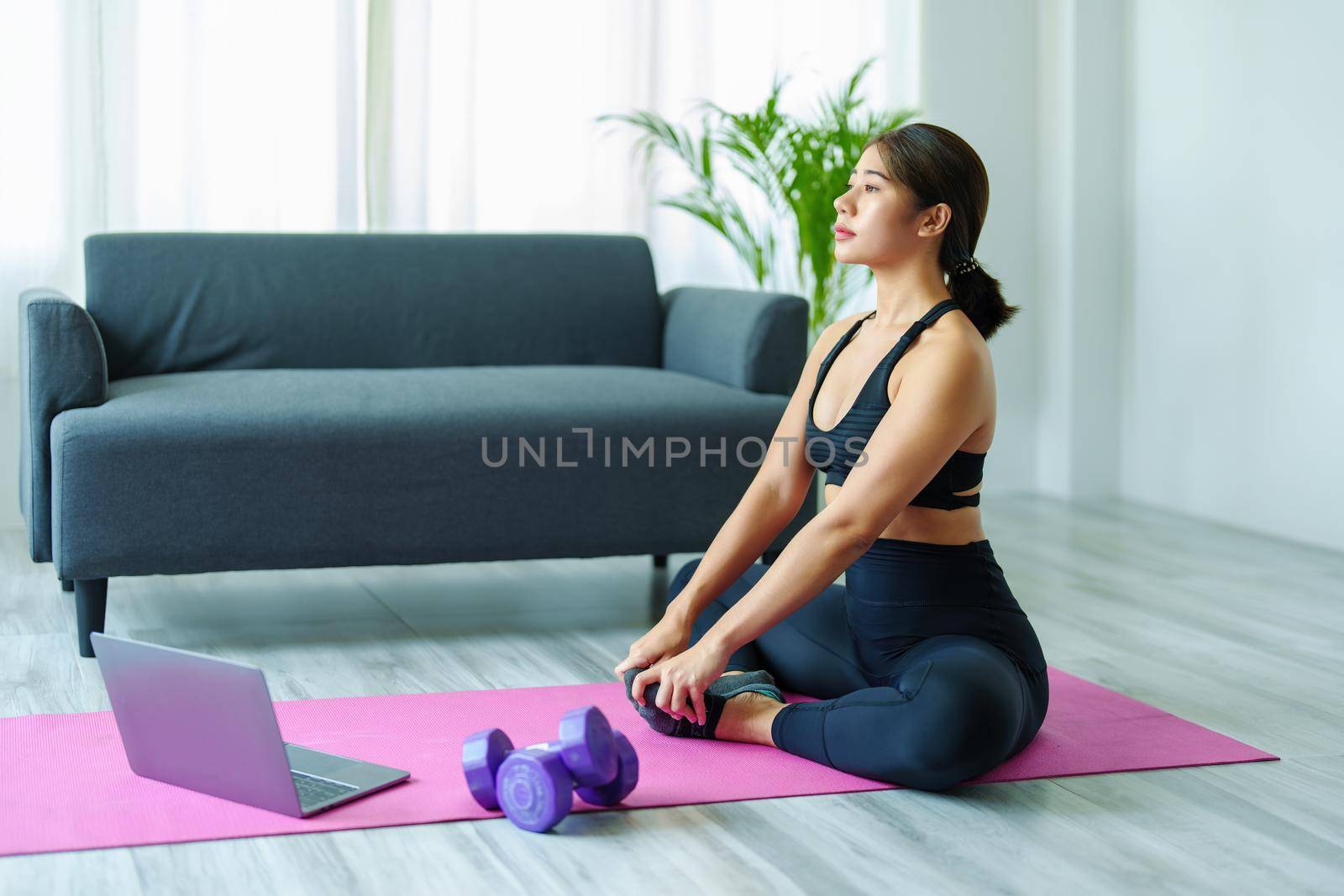 stress relief, muscle relaxation, breathing exercises, exercise, meditation, portrait of Young Asian woman relaxing her body from office work by practicing yoga by watching online tutorials