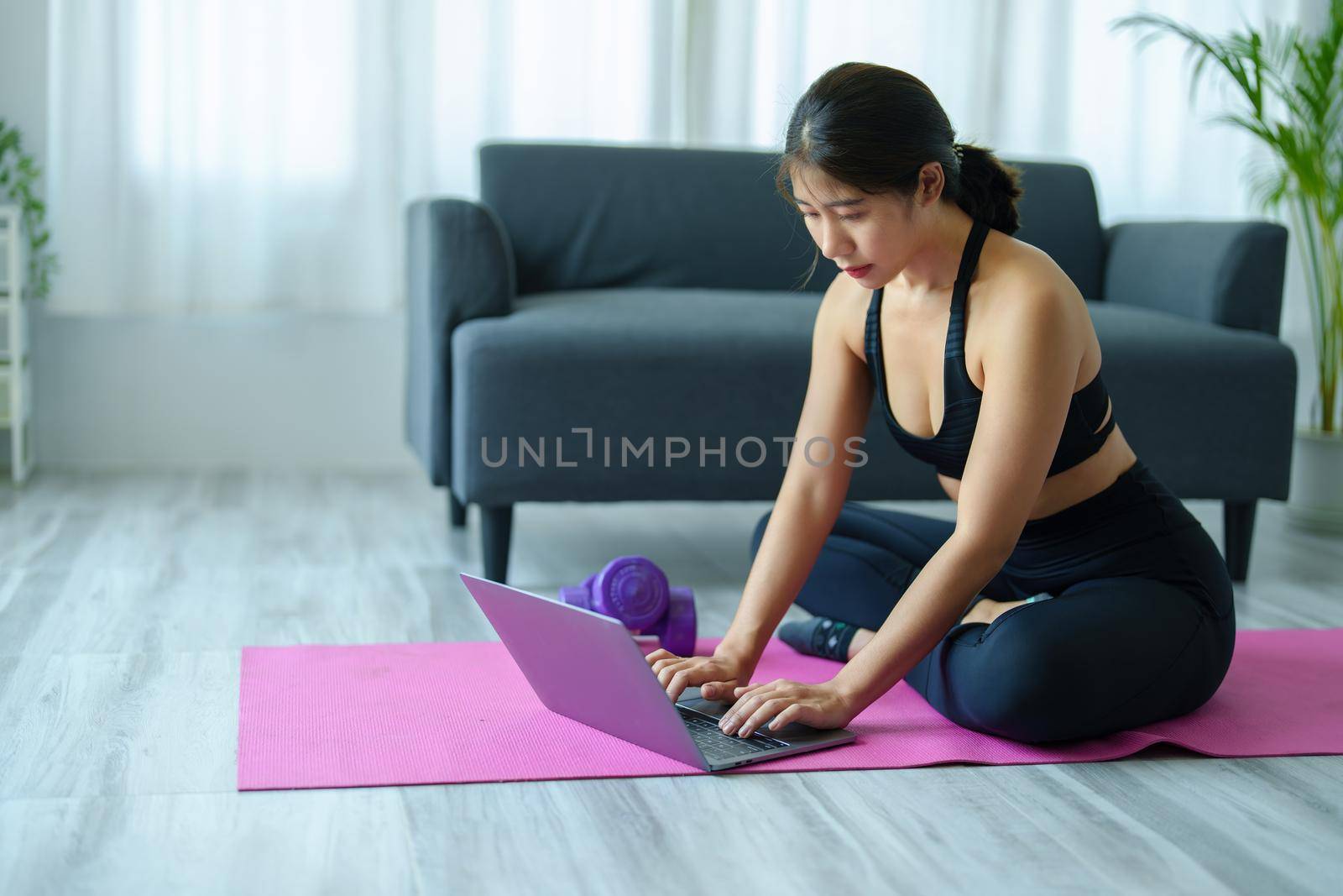 stress relief, muscle relaxation, breathing exercises, exercise, meditation, portrait of Young Asian woman relaxing her body from office work by practicing yoga by watching online tutorials