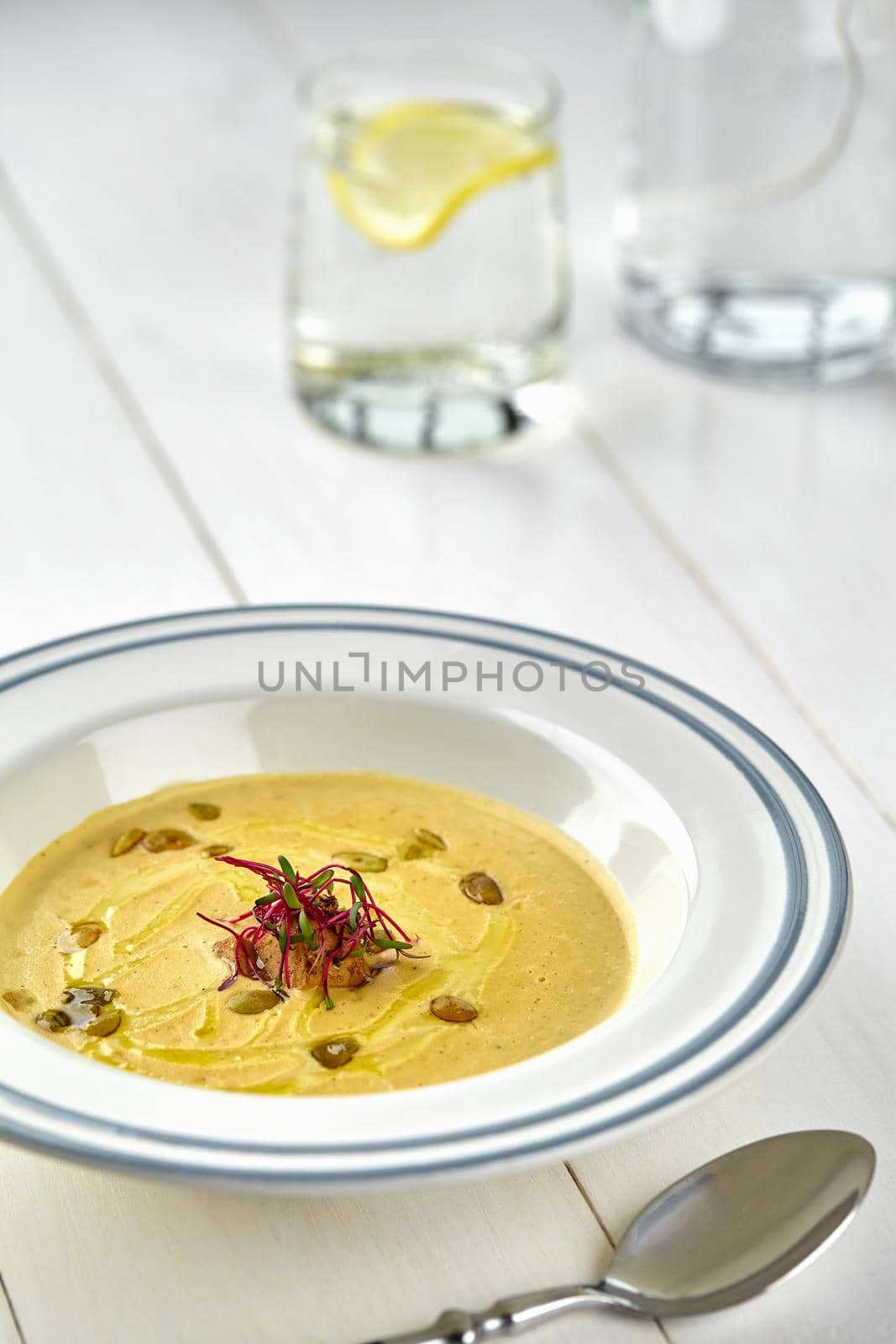 Healthy dinner with pumpkin soup-puree served in white bowl by nazarovsergey