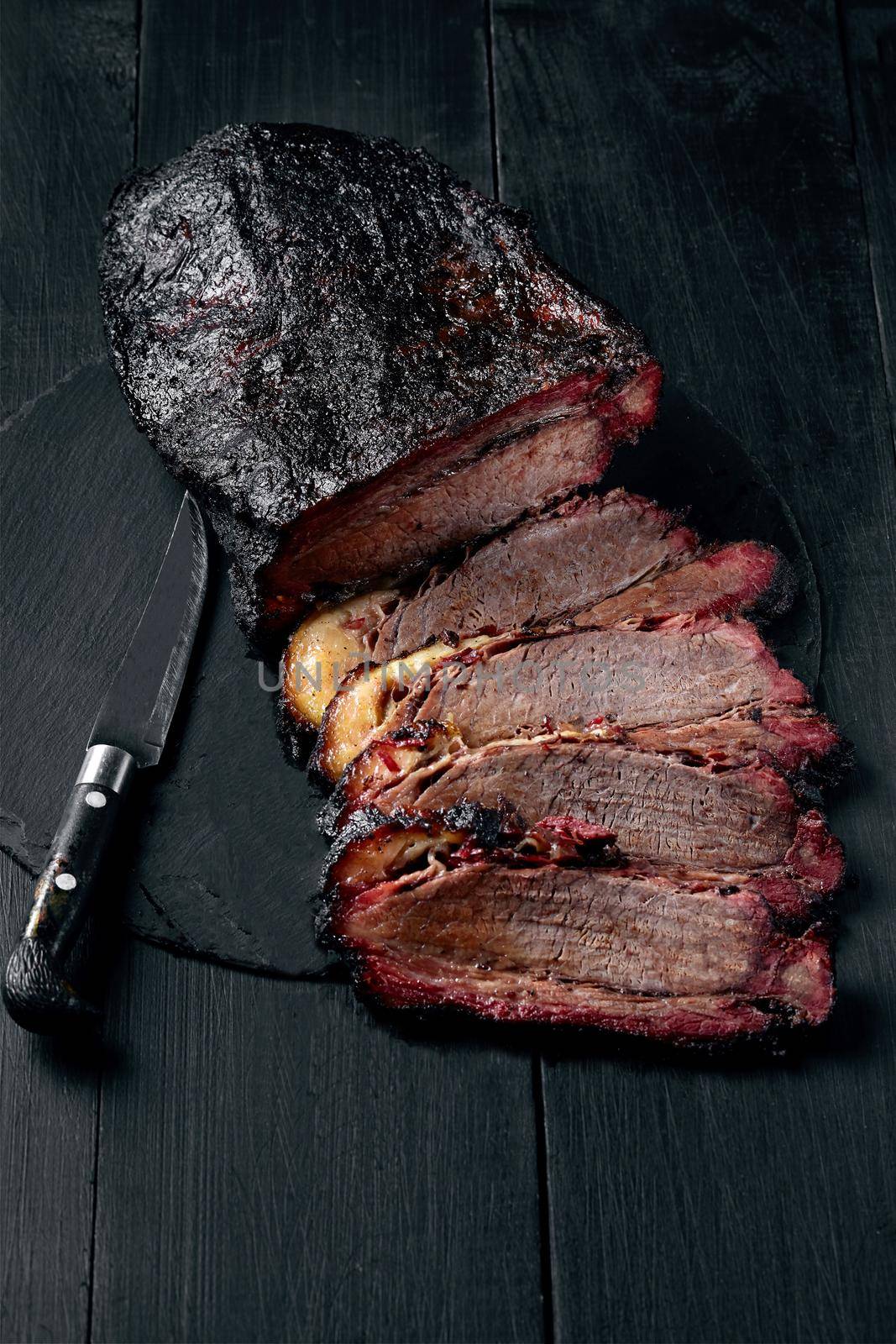 Fresh Brisket BBQ beef sliced for serving against a dark background by nazarovsergey