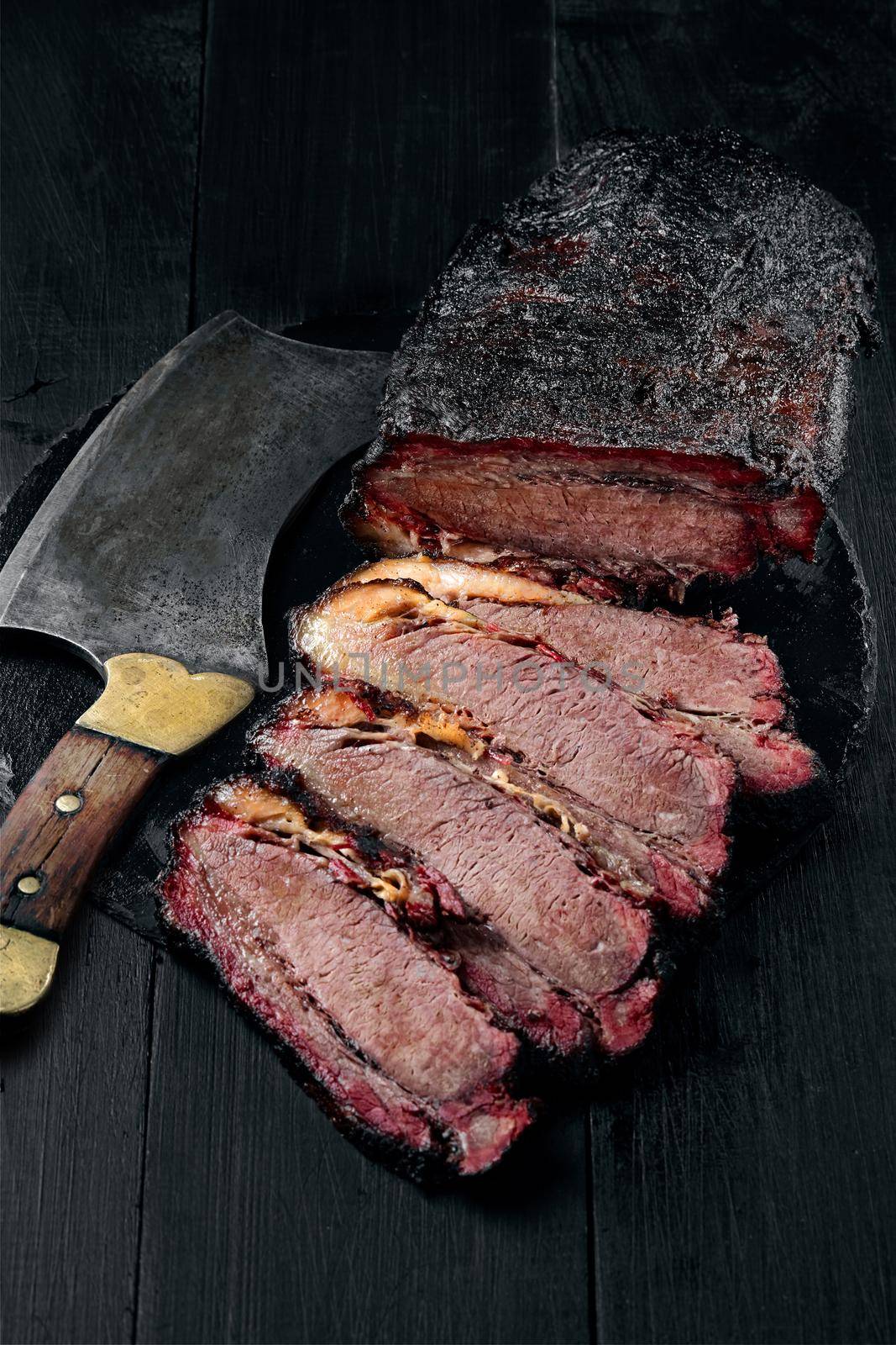 Fresh Brisket BBQ beef sliced for serving against a dark background. Generous accommodation for copy space. American style