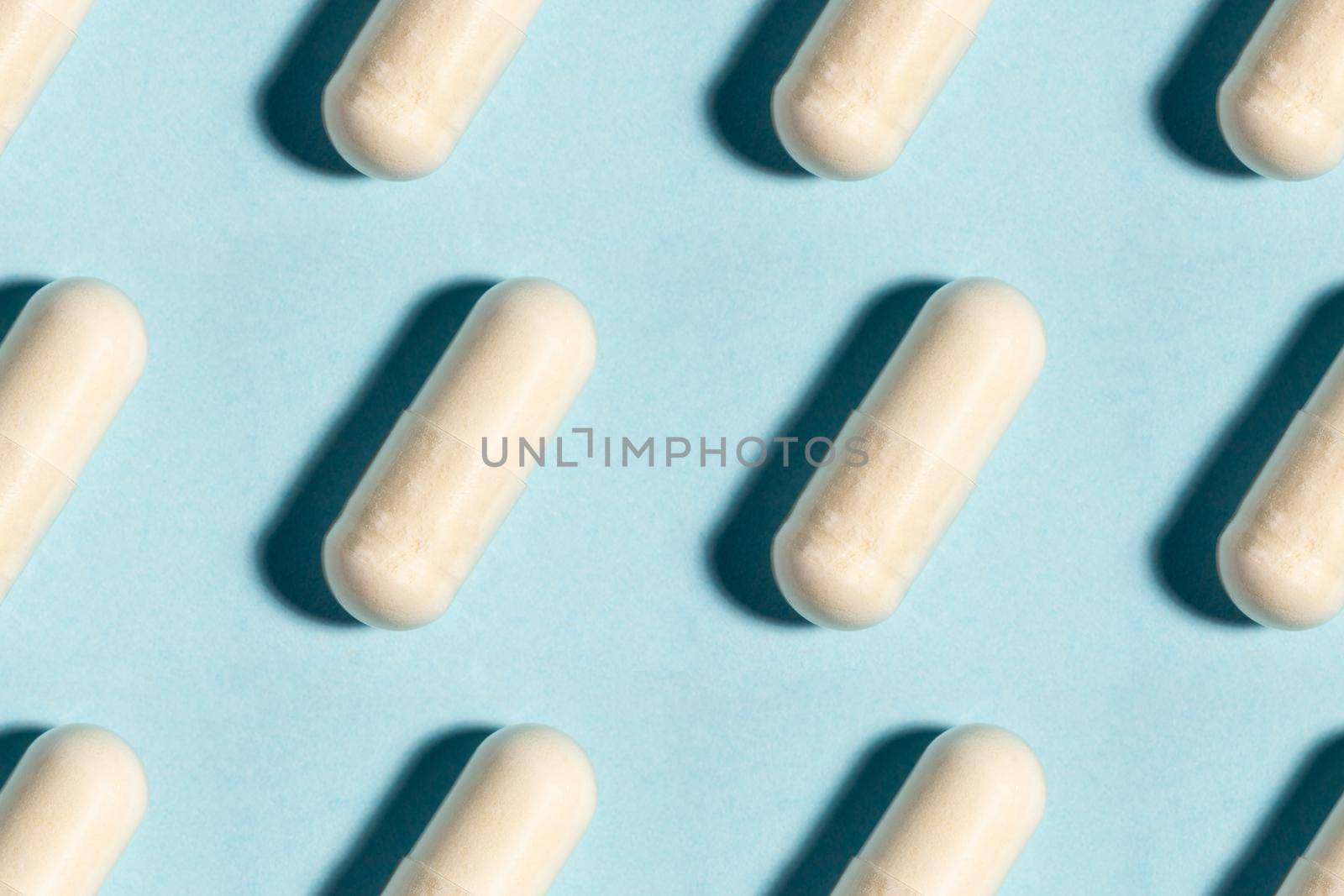 Seamless medical pill, pharmaceutical medicine capsule pattern. Painkiller, vitamin, antibiotic, probiotic on blue background. Medical concept. Science concept background. Close up.