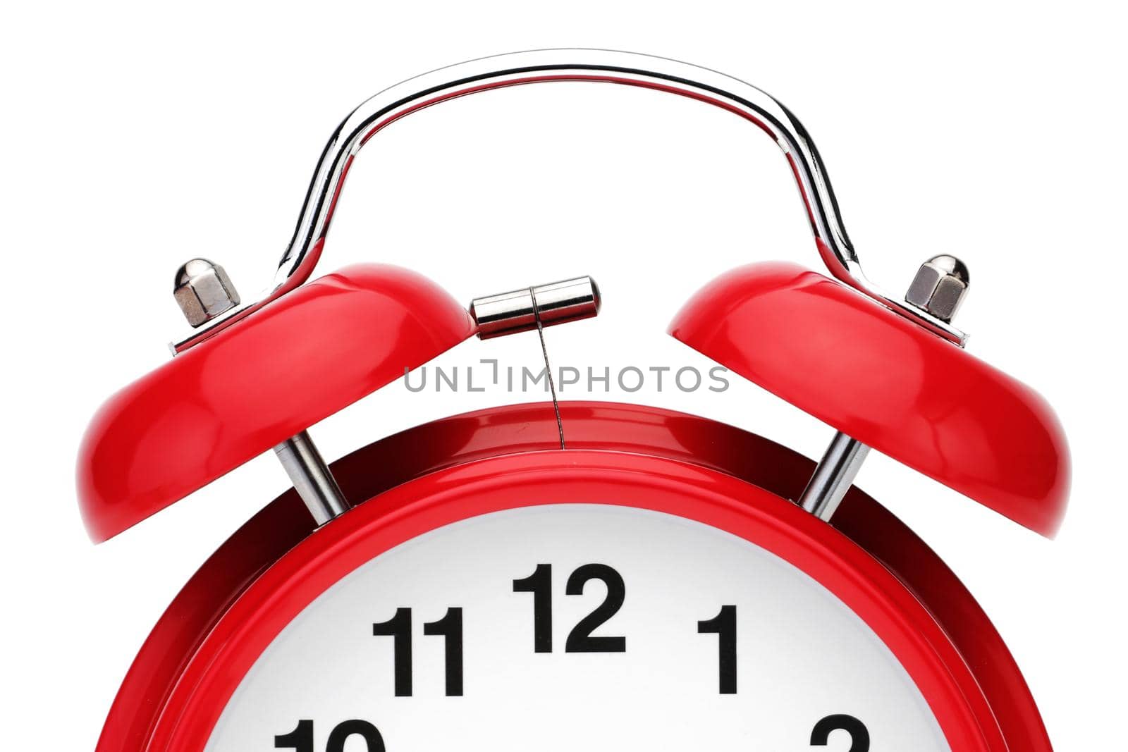A pair of alarm bells on a red retro alarm clock