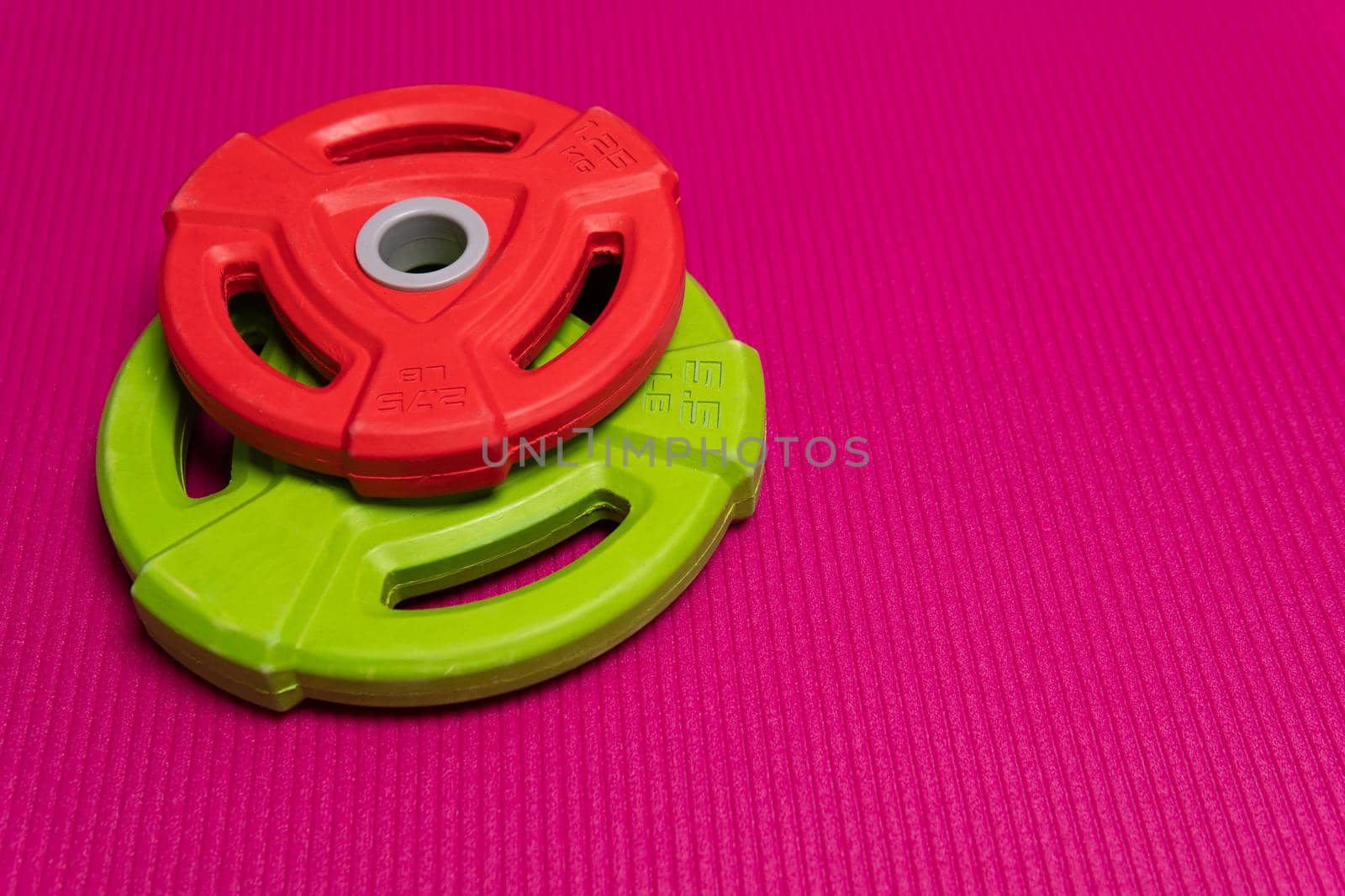 Red pancakes equipment green sport metal steel health fitness, for dumbbell workout for space for top view, activity empty. Design club concept,