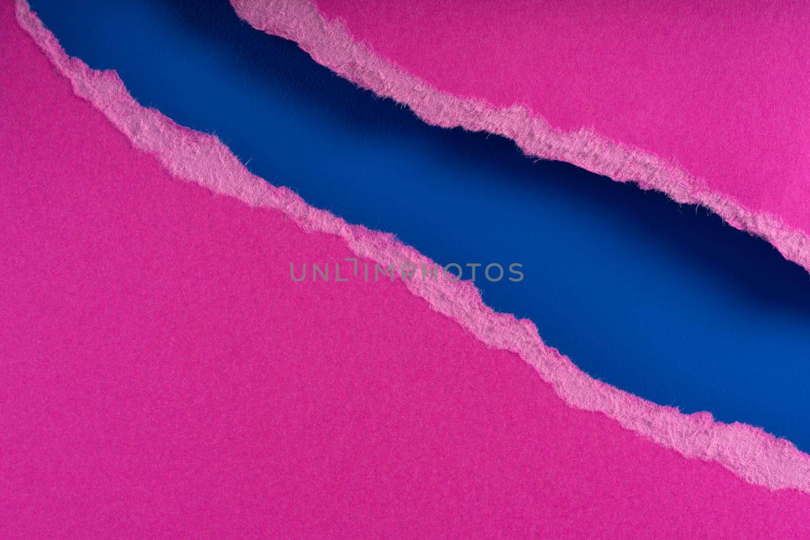 Pieces of torn ragged purple paper edges on blue background. Ripped cracked paper edge isolated with soft shadow. by photolime