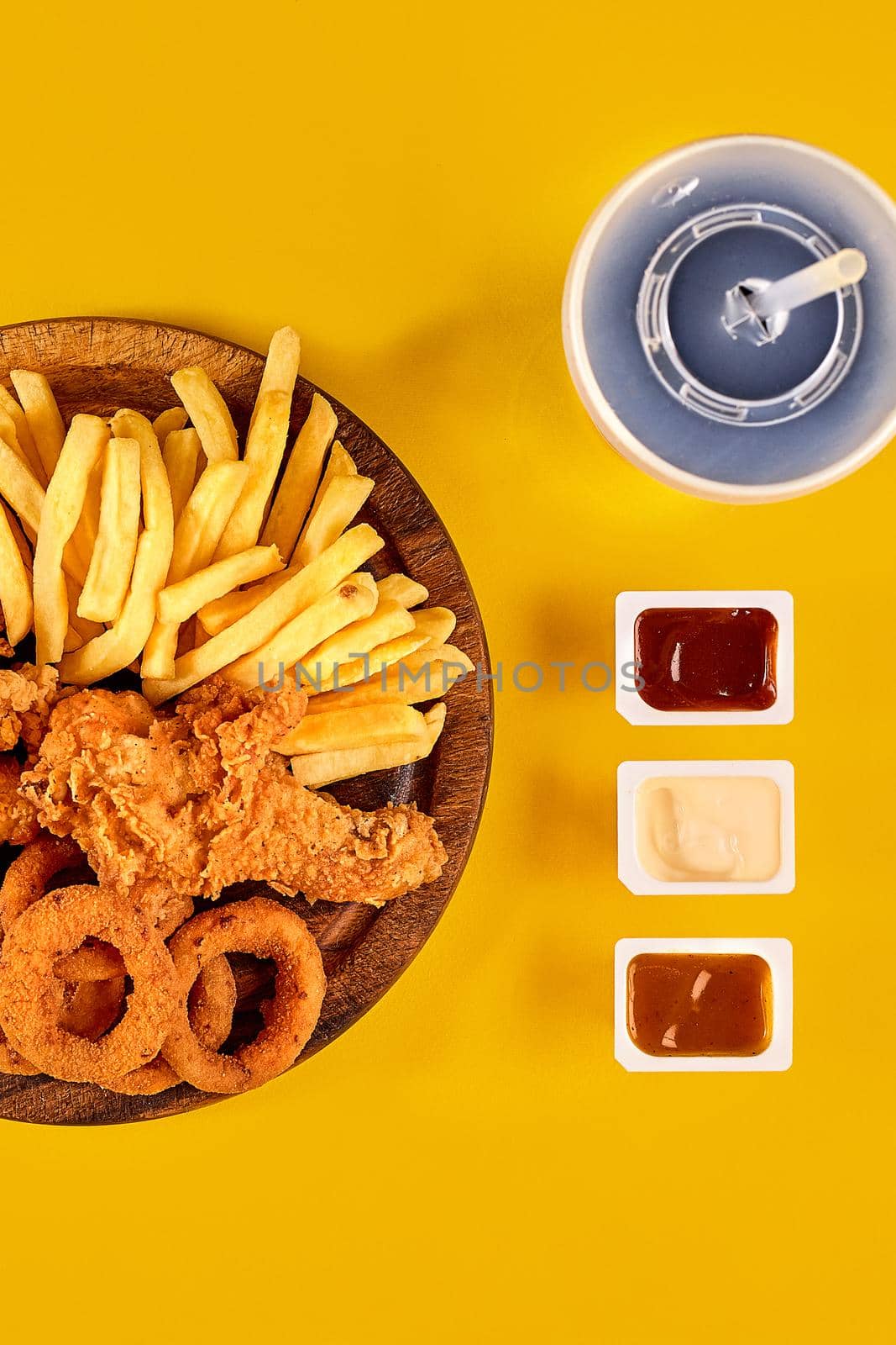 Fast food dish on yellow background. Fast food set fried chicken and french fries. Take away fast food. by nazarovsergey