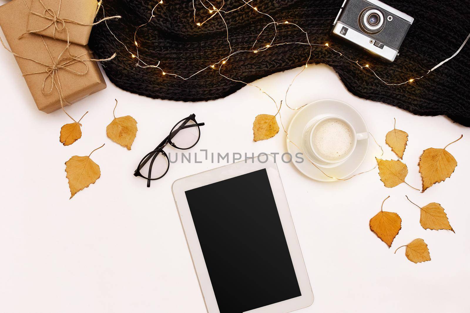 Autumn accessories for woman with yellow leaves and coffee with milk, top view. Flat lay. Copy space. Still life