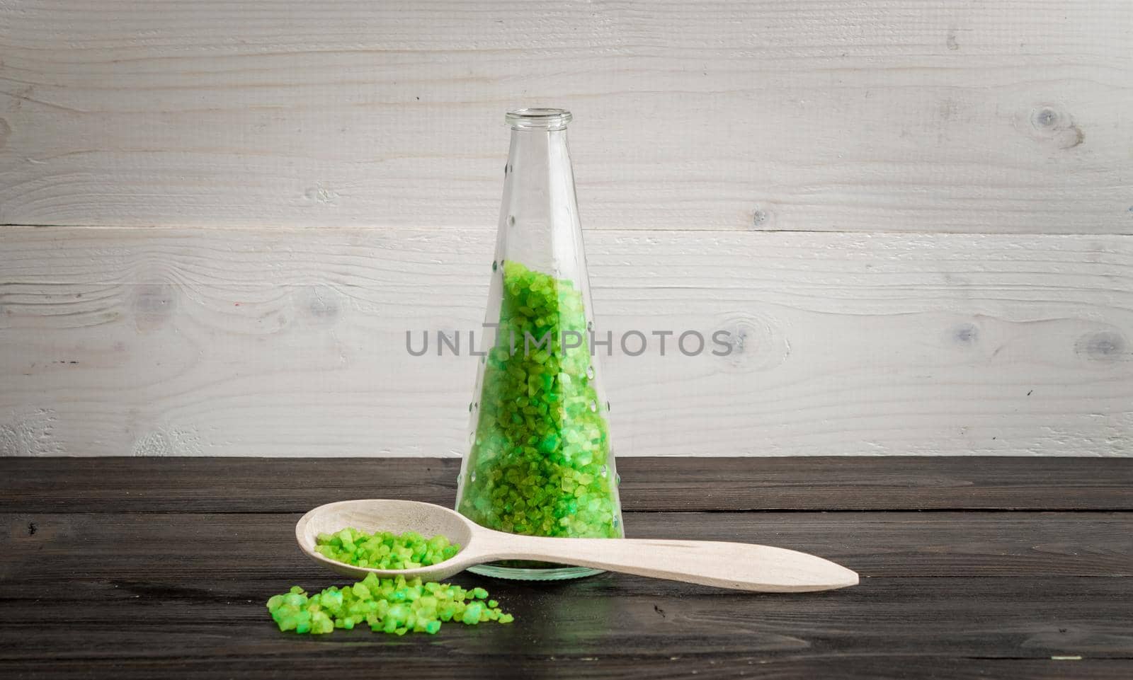 Green bath salt for spa on wooden spoon. SPA. Still life. Copy space