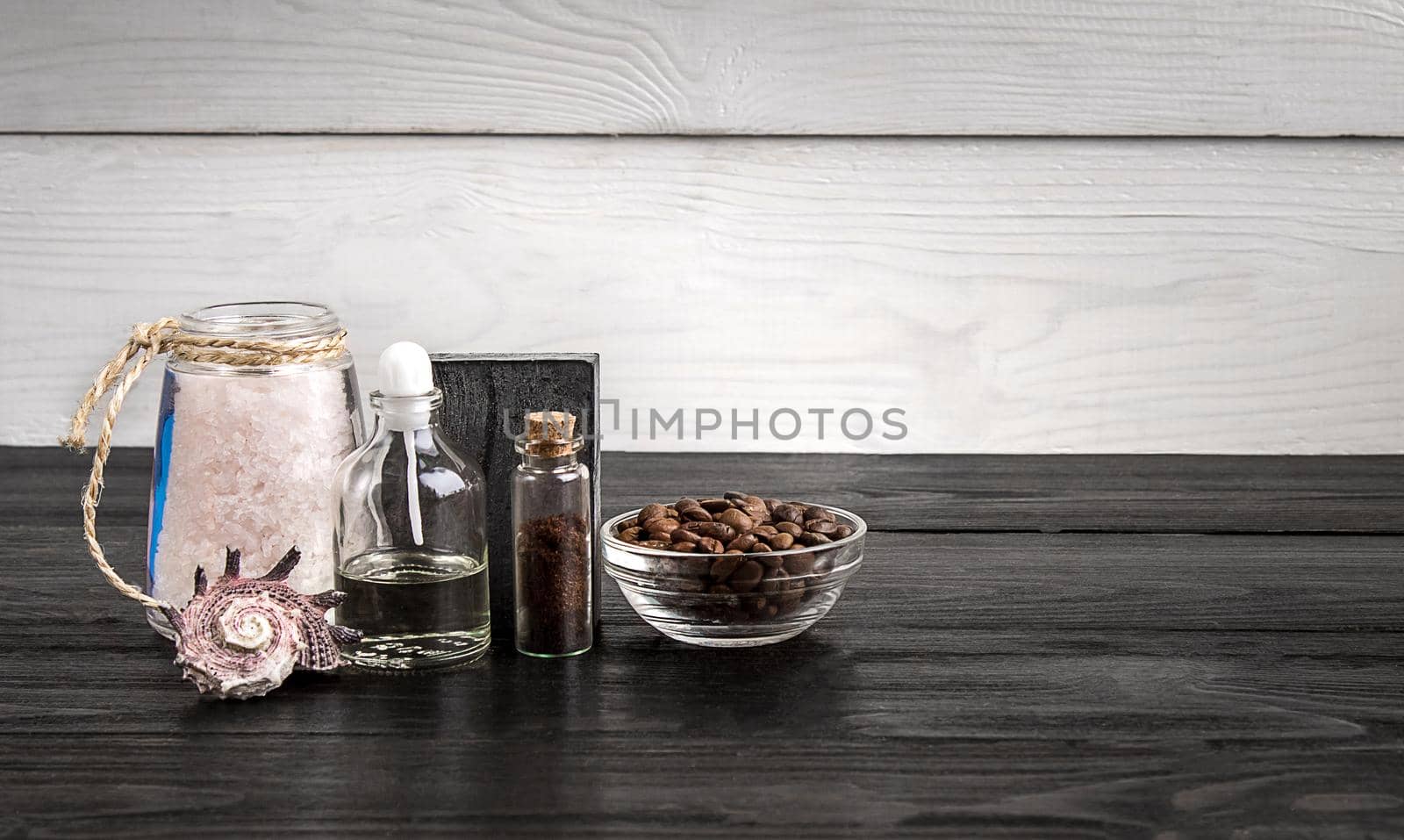 Composition of oil bottles and soap on black wooden background. Still life. Copy space. SPA set