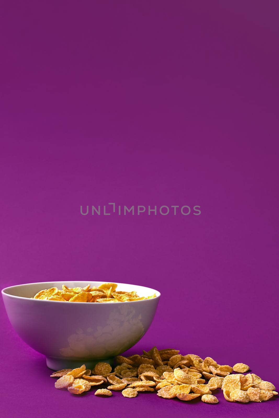 Bowl with cornflakes on the colorful background by nazarovsergey