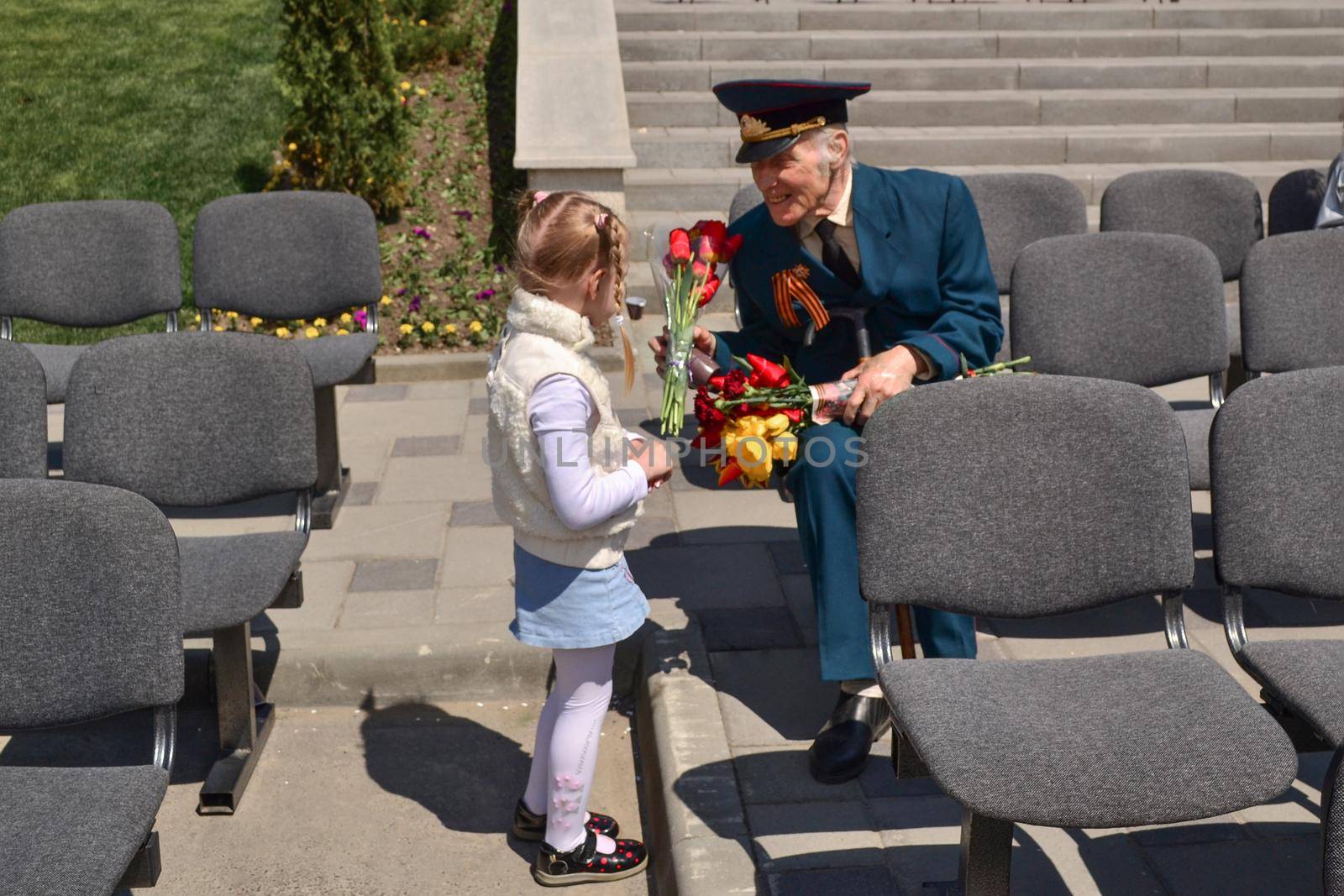 PYATIGORSK, RUSSIA - MAY 09, 2011: Girl gives flowers to veteran on Victory Day