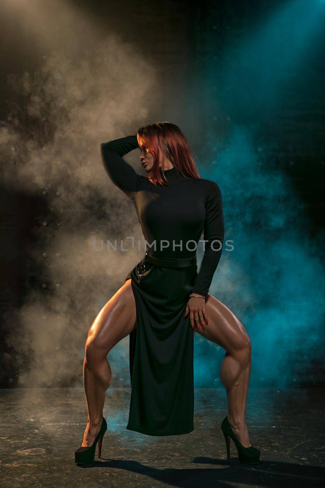 Red-haired girl in a black dress posing in the studio by but_photo