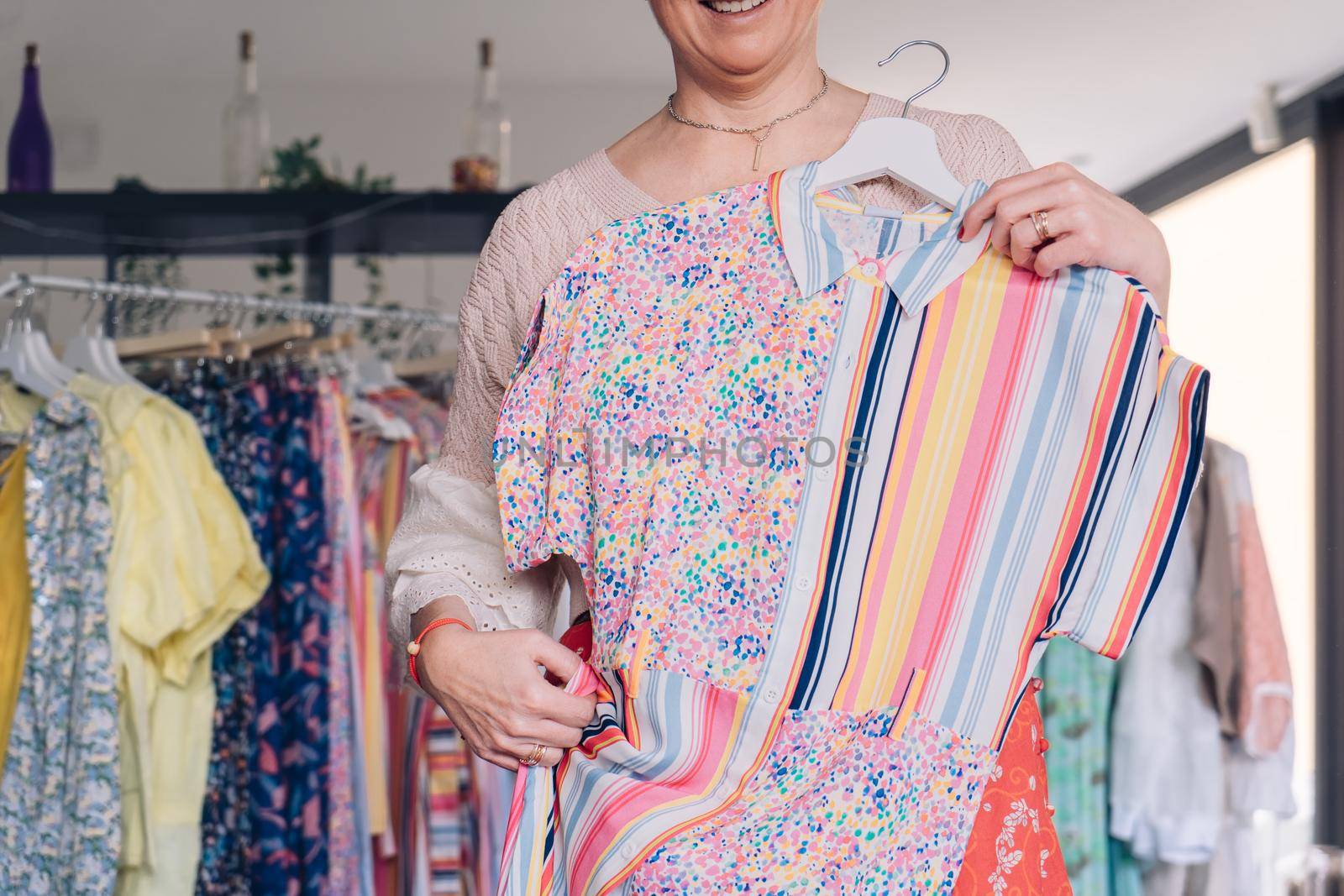 cropped shot of a woman shopping for clothes in a fashion shop. concept of shopping. leisure concept by CatPhotography