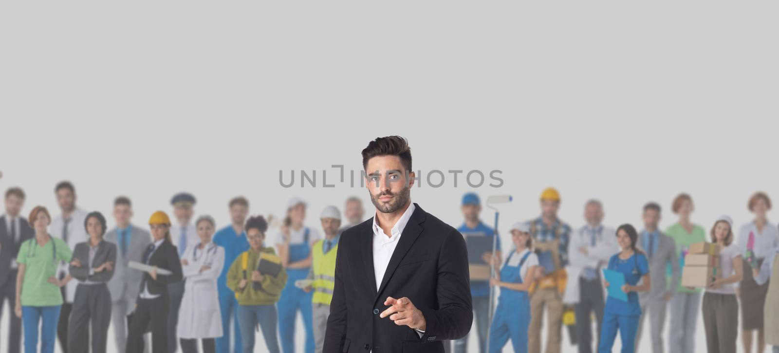 Businessman pointing at you in front of crowd of different industries professions people cooperation job search staff management concept