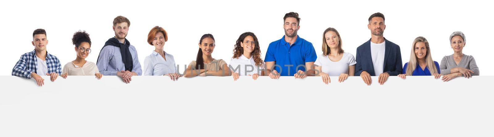 Large group of mixed race people holding together blank sign with copy space for text