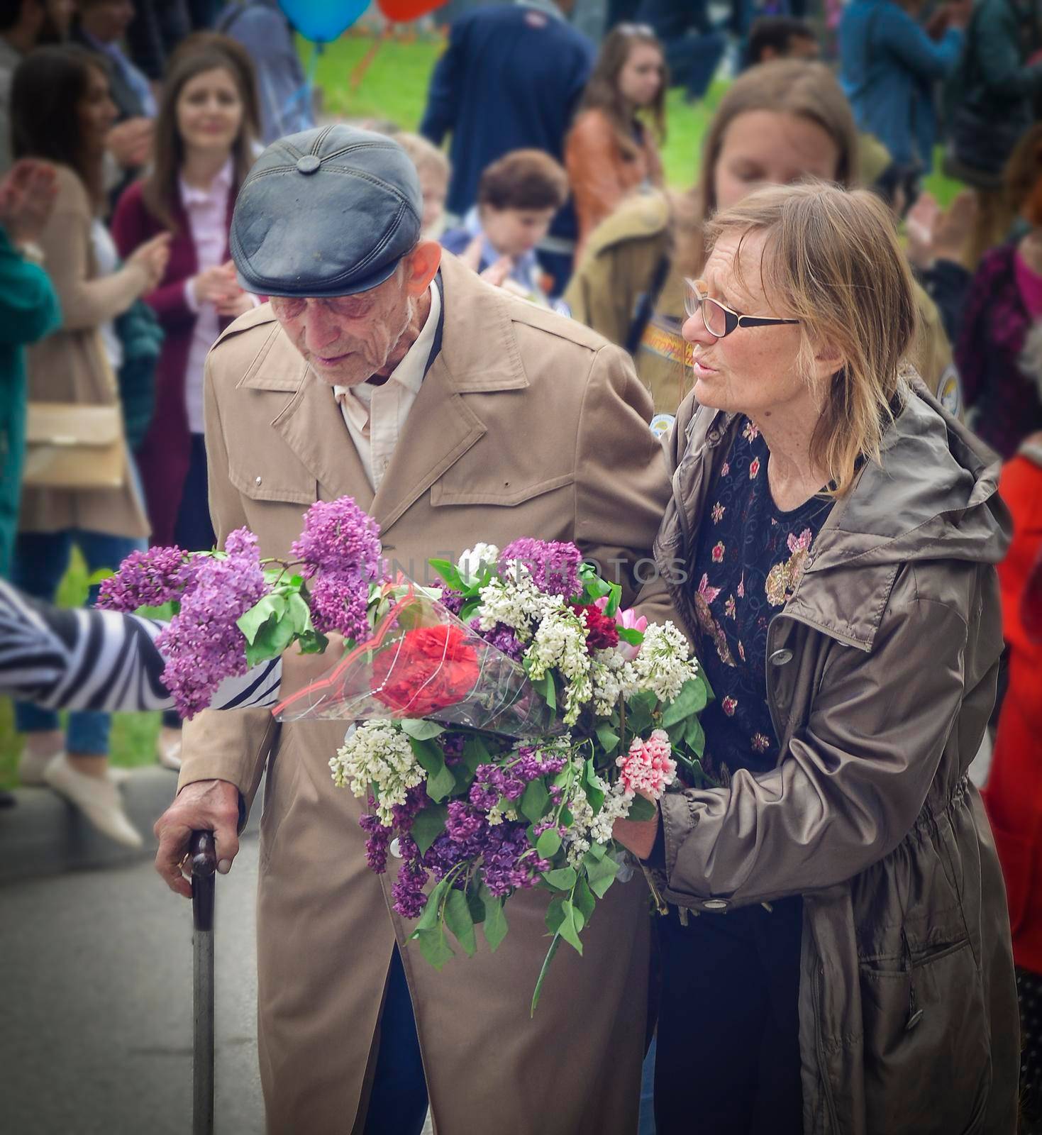 PYATIGORSK, RUSSIA - MAY 09, 2017: Carer and elderly man with a walking stick on Victory Day on a parade of 9 may