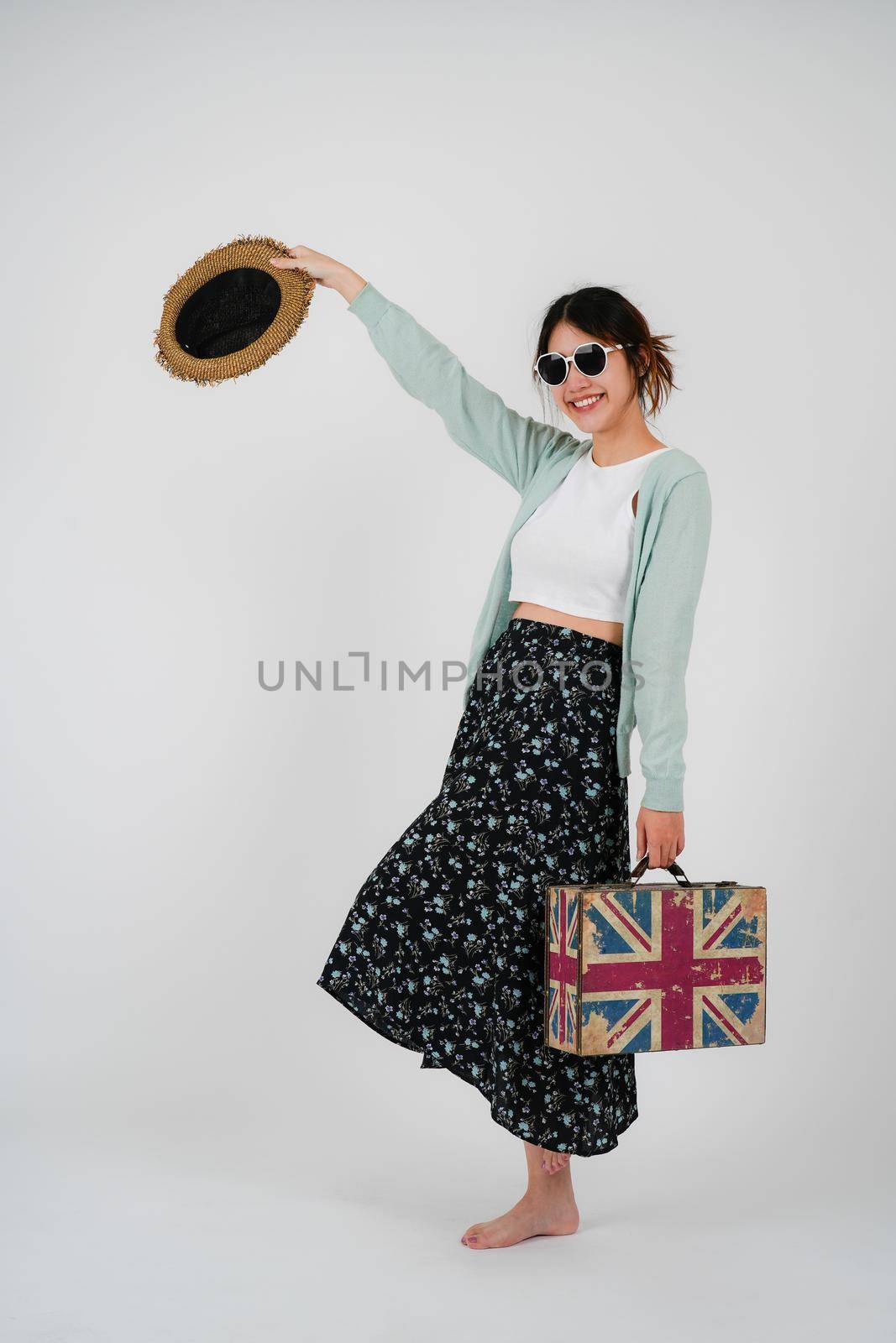 Portrait asian woman tourist with travel suitcase with sunglasses, isolated on white background - summer travel concept. by nateemee