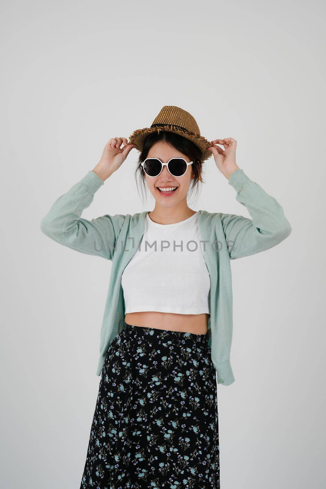 Asian girl tourist wearing sunglasses and hat, isolated on white background. summer travel concept by nateemee
