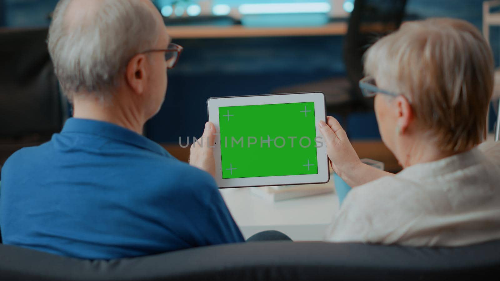 Senior people holding digital tablet with green screen by DCStudio