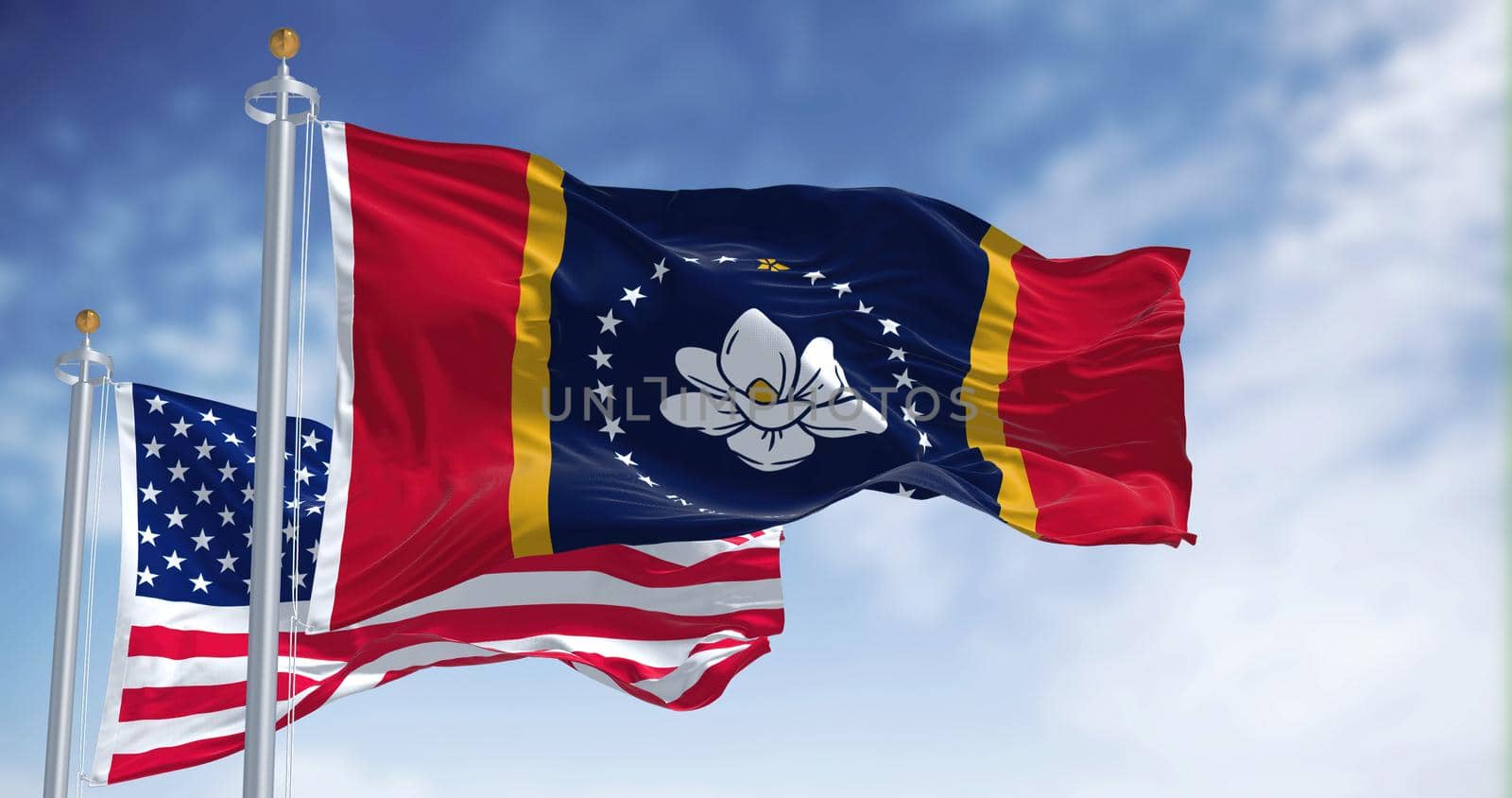 The Mississippi state flag waving along with the national flag of the United States of America. Mississippi is a state in the Southeastern region of the United States. Democracy and independence.