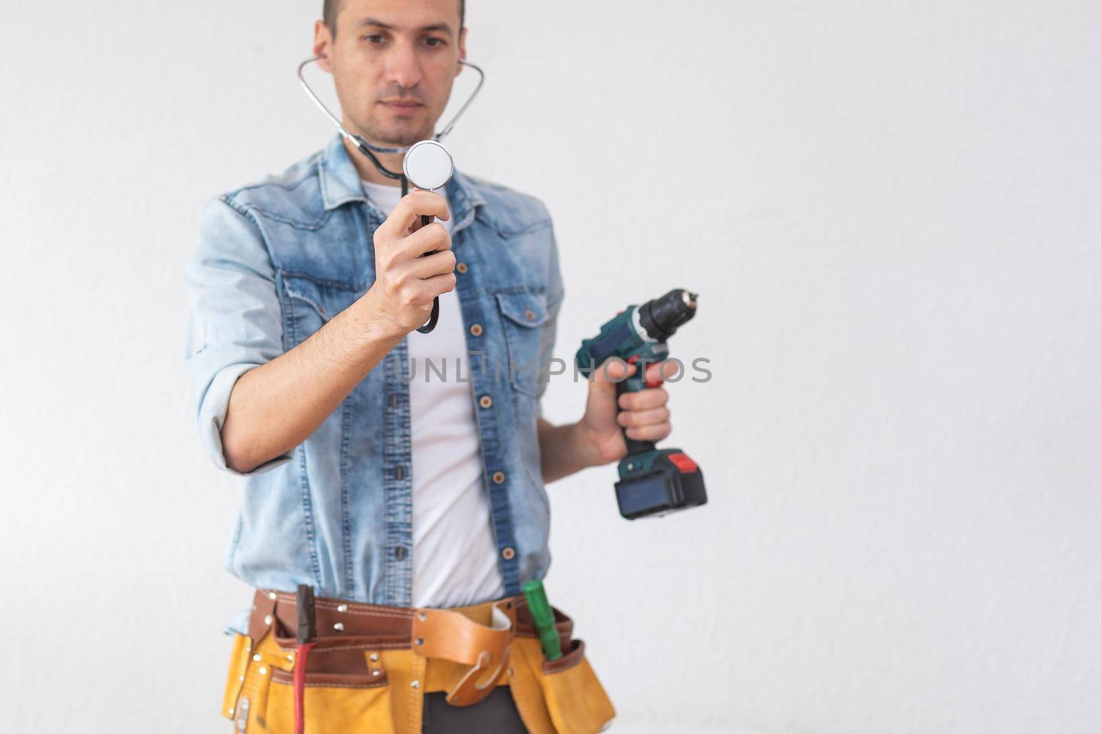 mechanic working with a stethoscope isolated on white background.