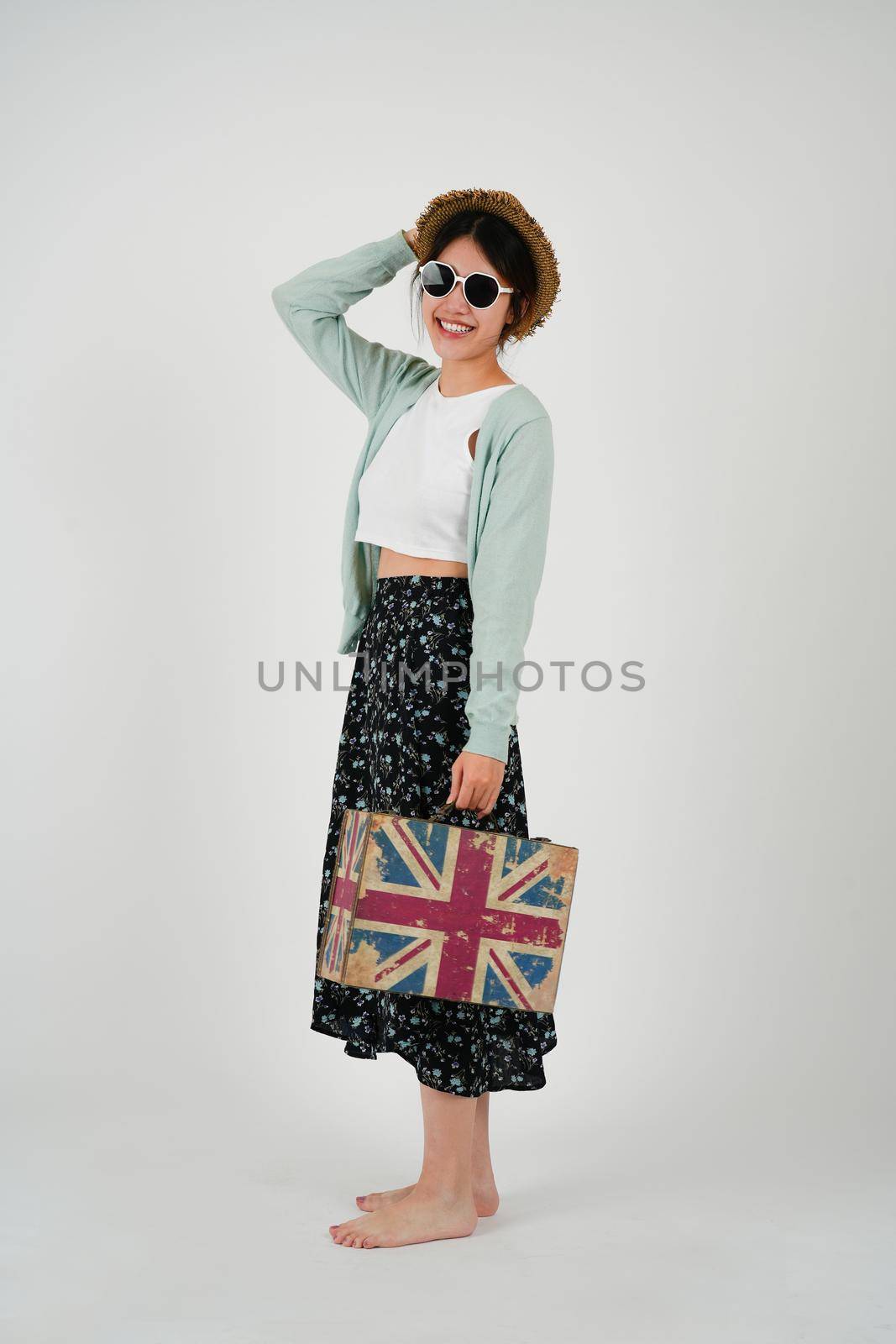Portrait asian woman tourist with travel suitcase with sunglasses, isolated on white background - summer travel concept