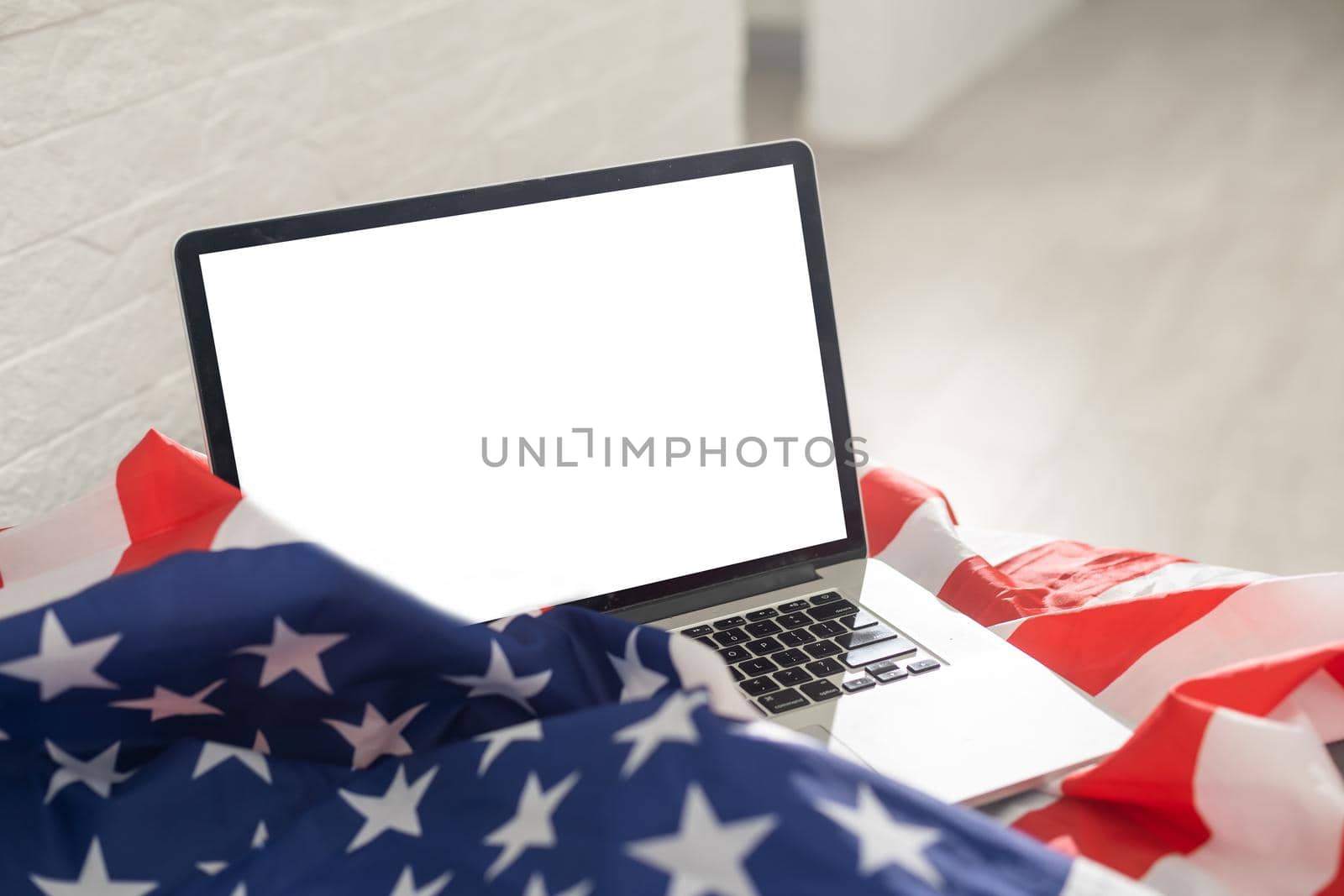 Laptop with blank screen and USA flag.