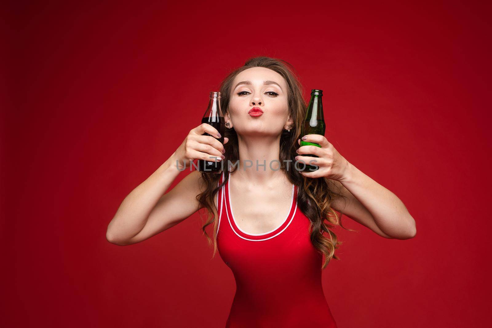 Beautiful female model posing on red background.