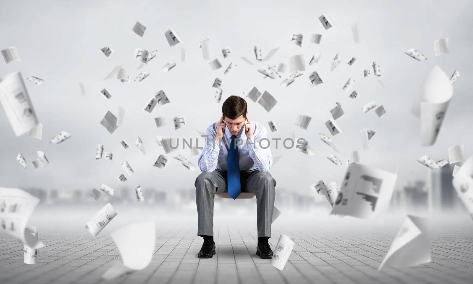 Businessman is sitting on an office chair with his head in his hands. Business stress and problems