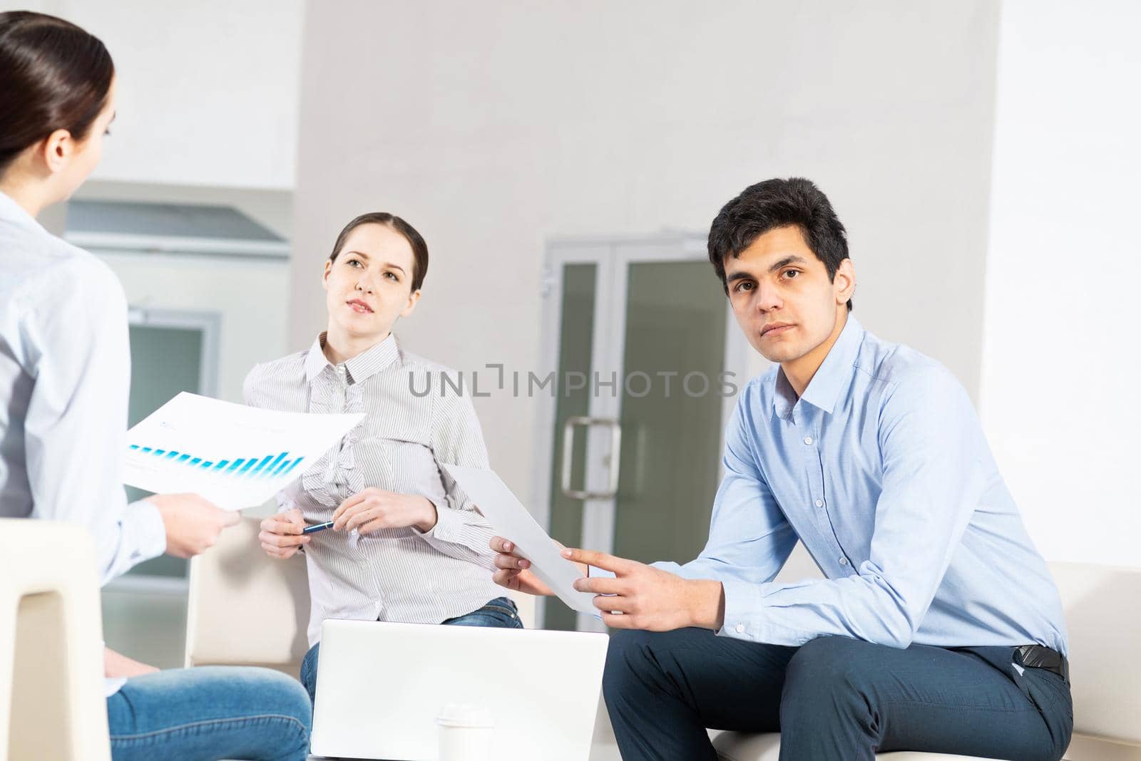 portrait of a young man at a business meeting. concept of team work