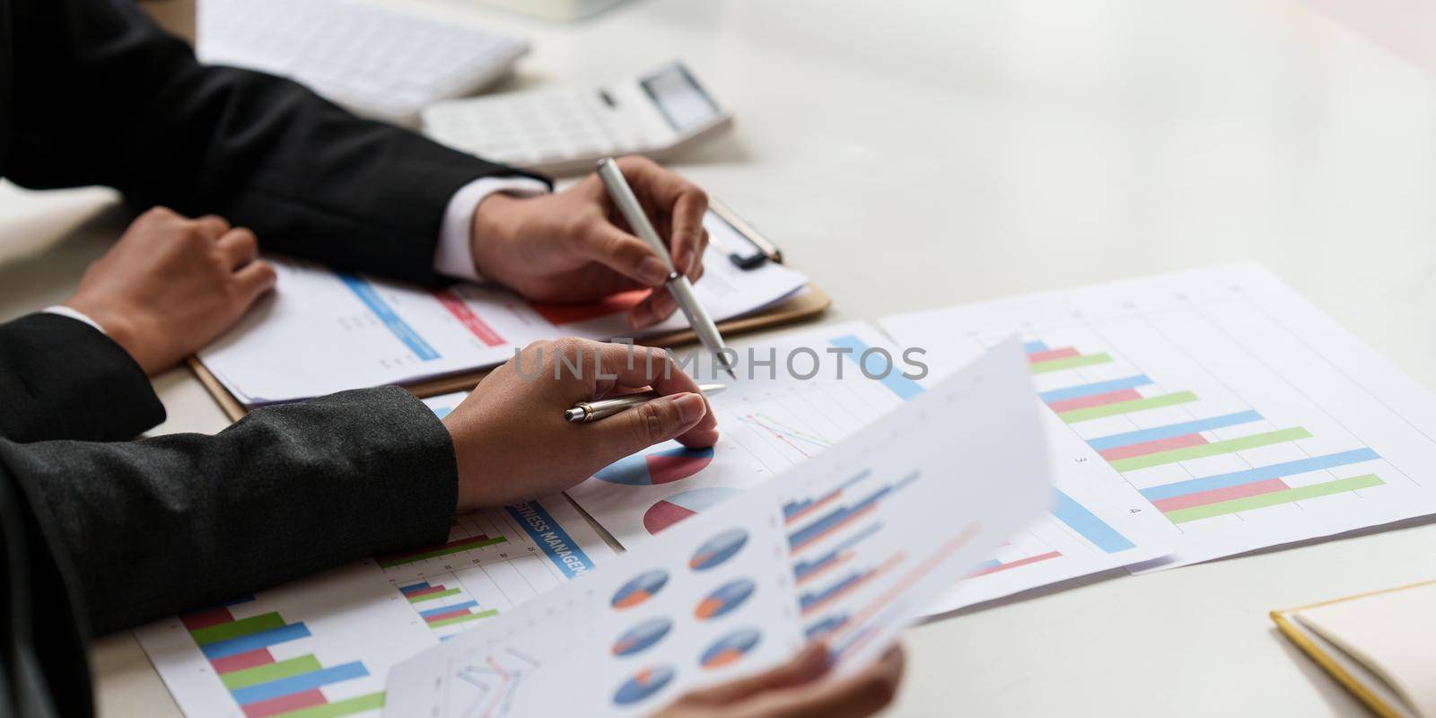 Consult financial concept. Business woman pointing at paperwork and using calculator