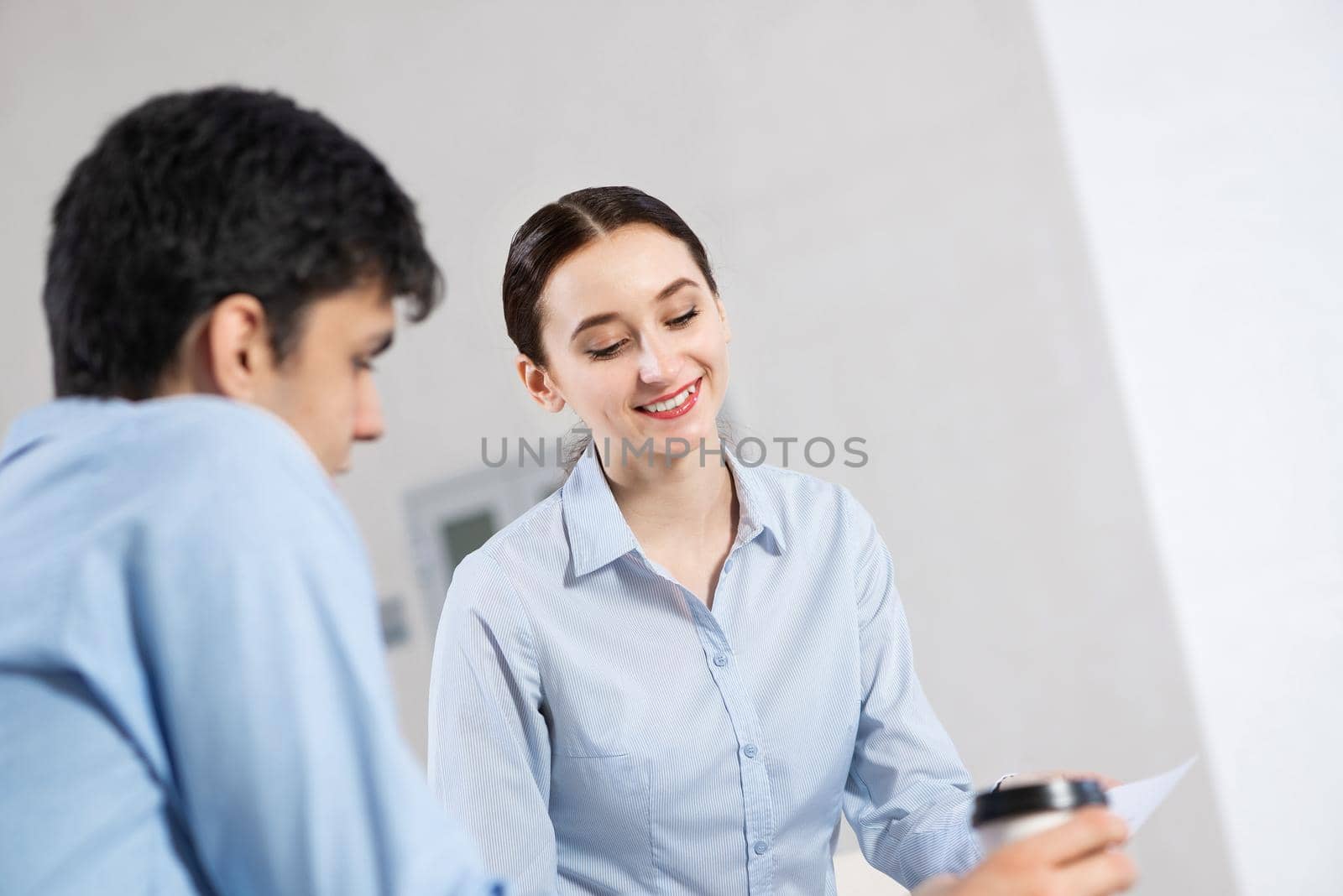 portrait of a young attractive woman discussing documents with a colleague. teamwork conceppt