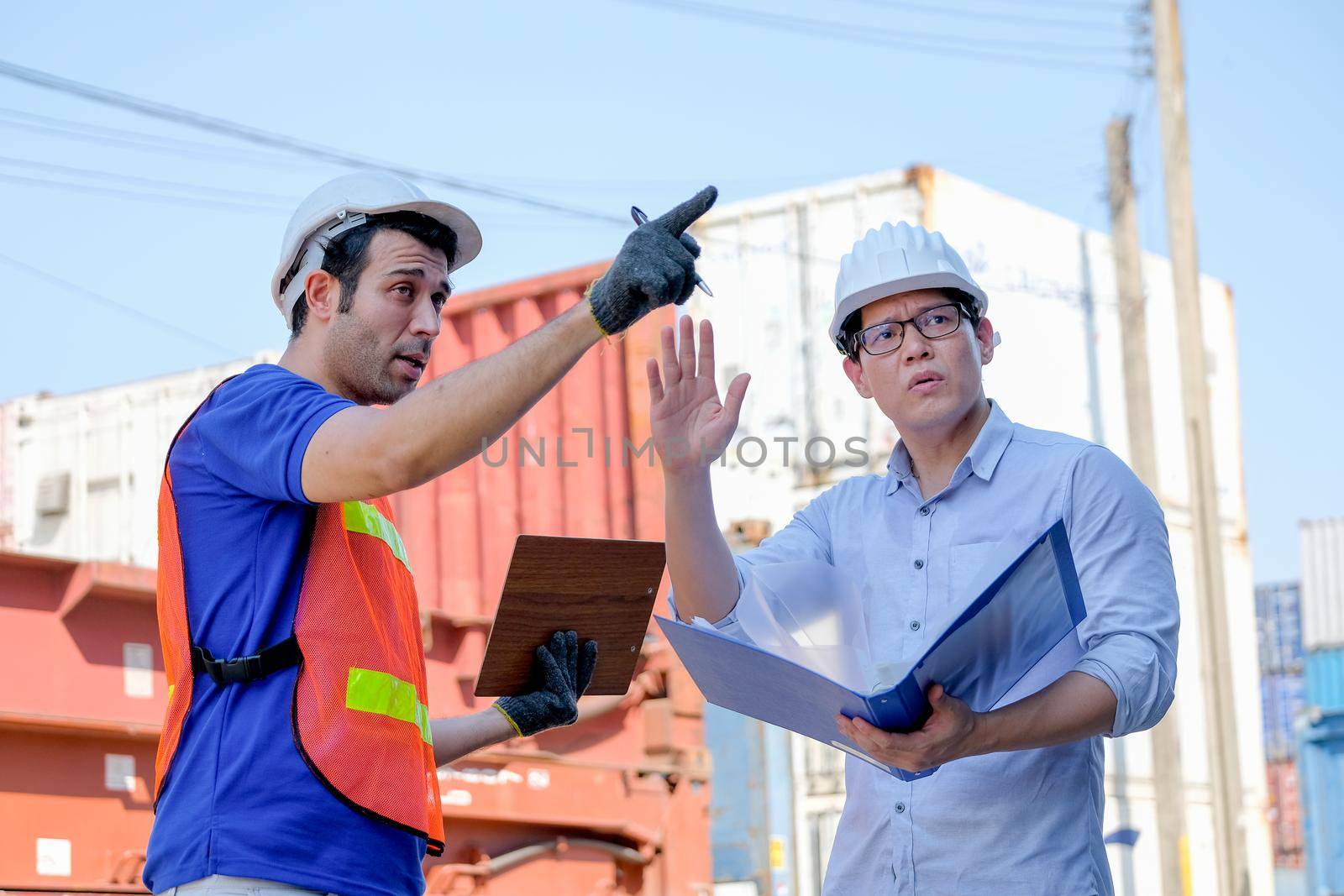 Technician and manager argue with the problem in cargo containers shipping area. by nrradmin