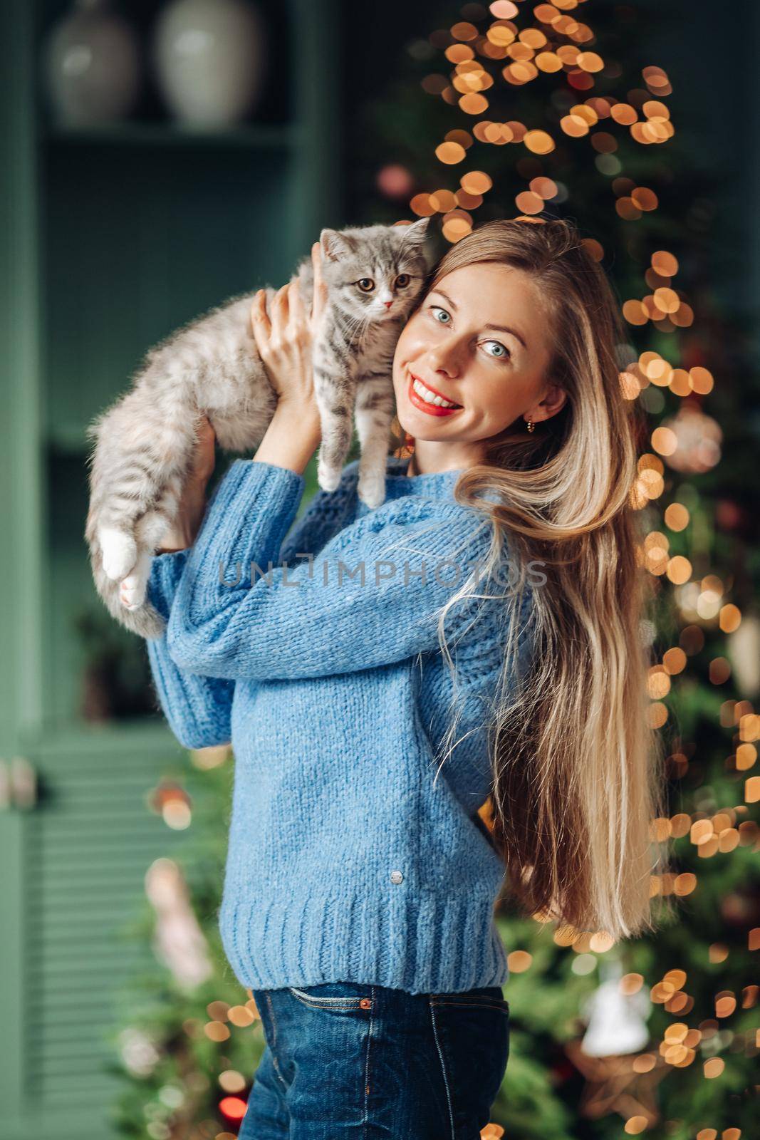 A woman with a cat hugs at home